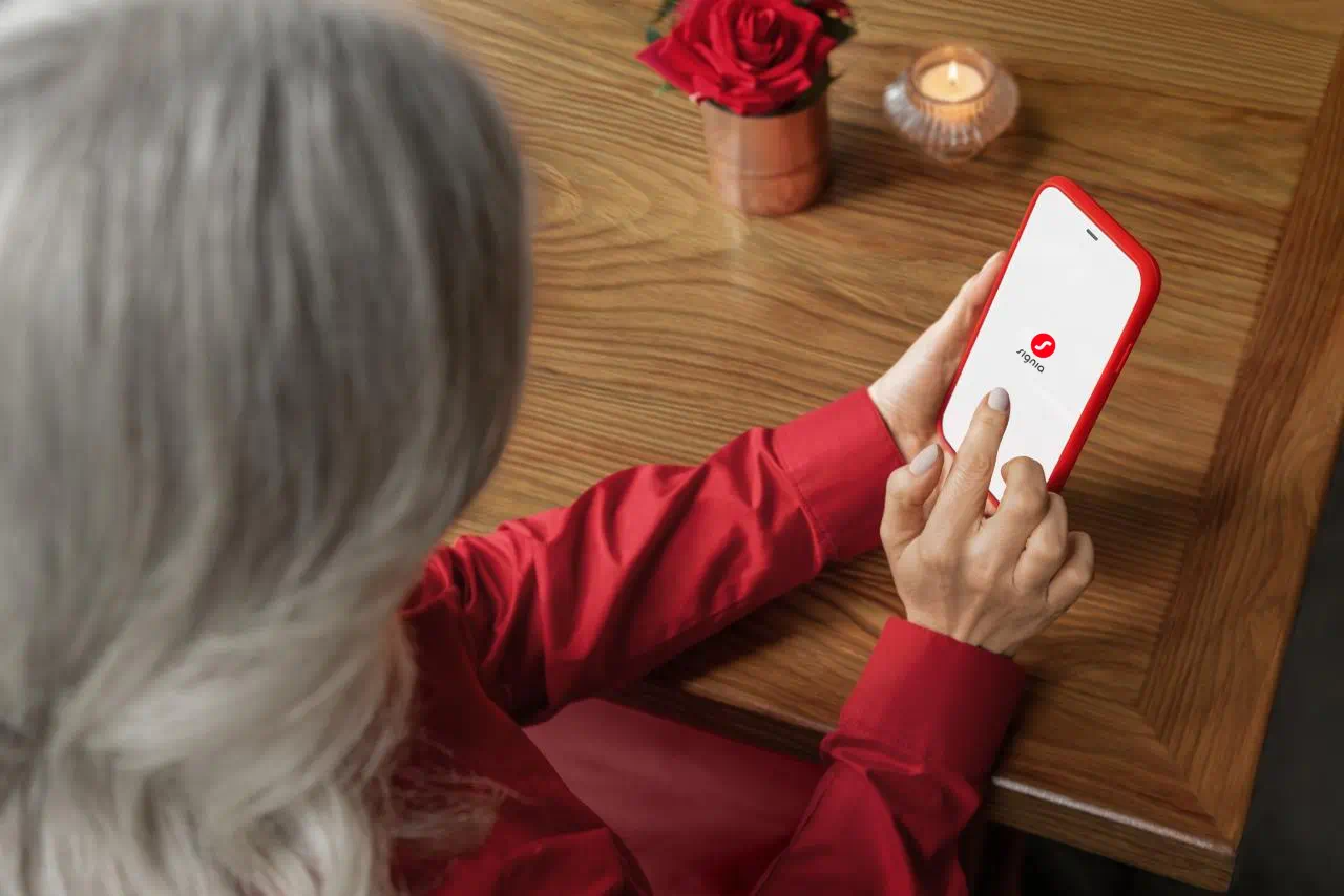 Woman using Signia app