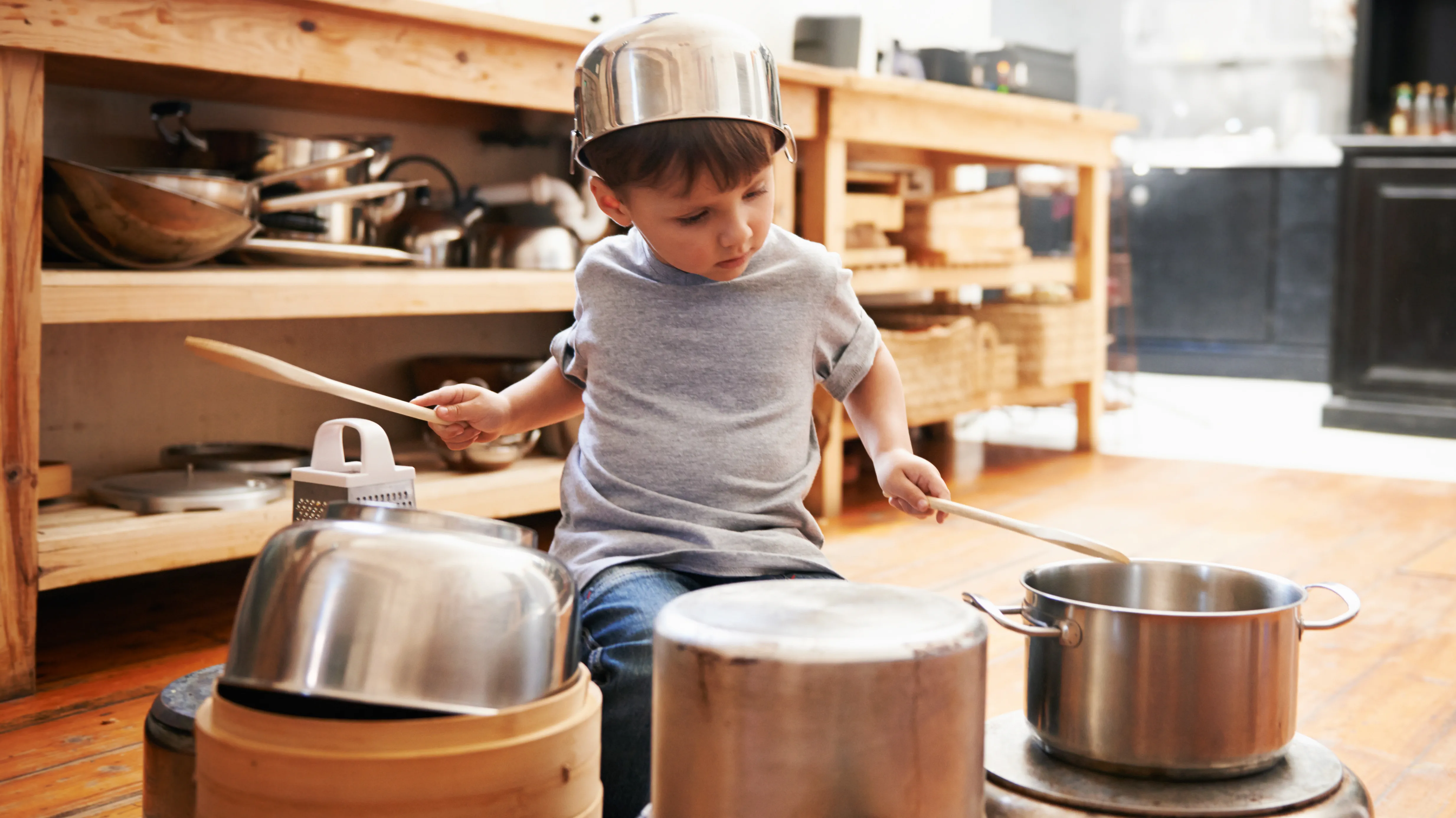 Boy playing, struggling to hear his surroundings because of hearing loss.