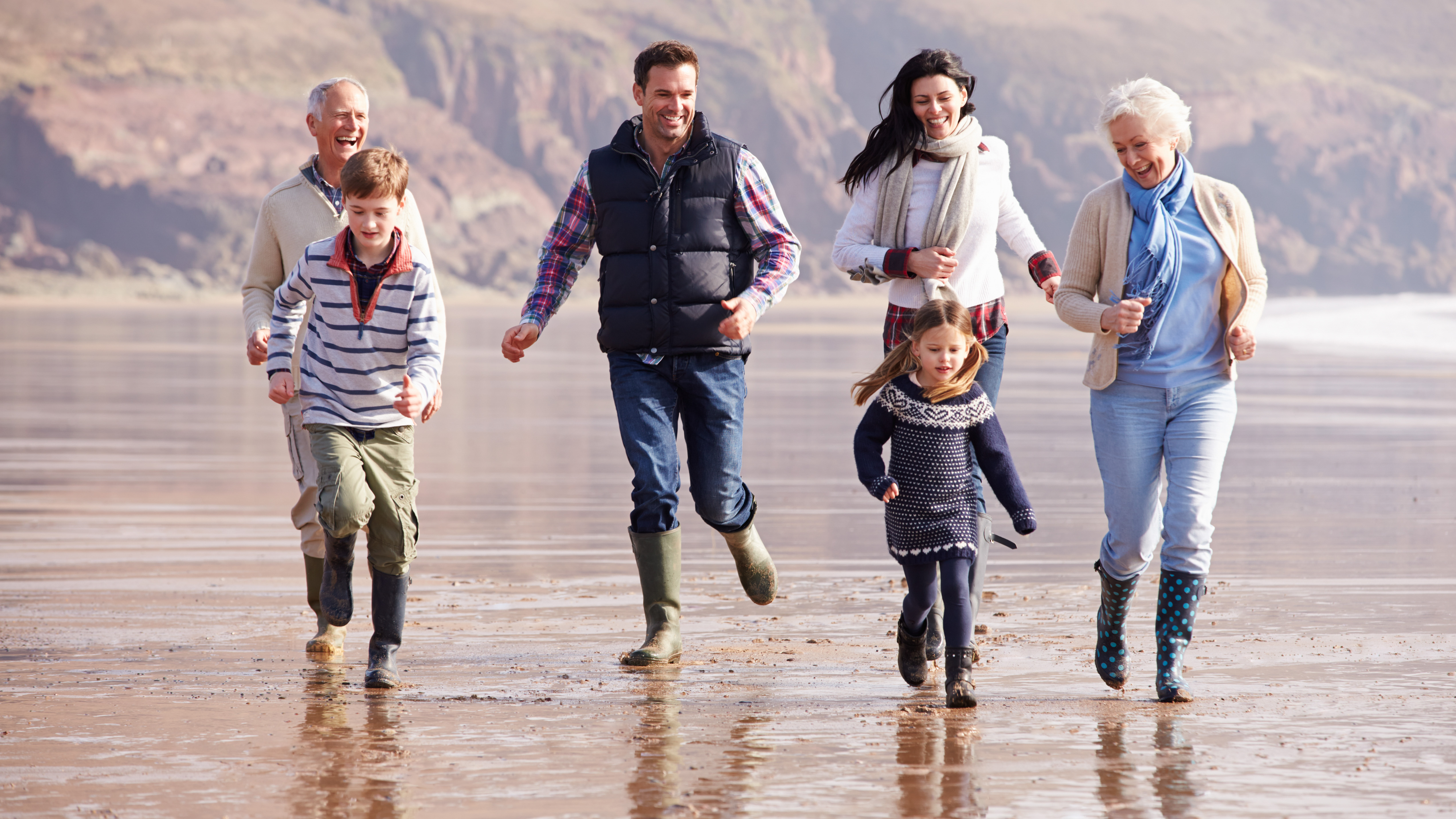 Family at the beach, where hearing loss makes it difficult to enjoy the sounds of the ocean.