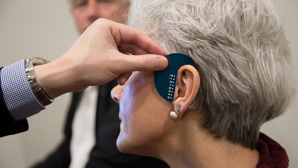 Measuring customers ears for hearing aids. 