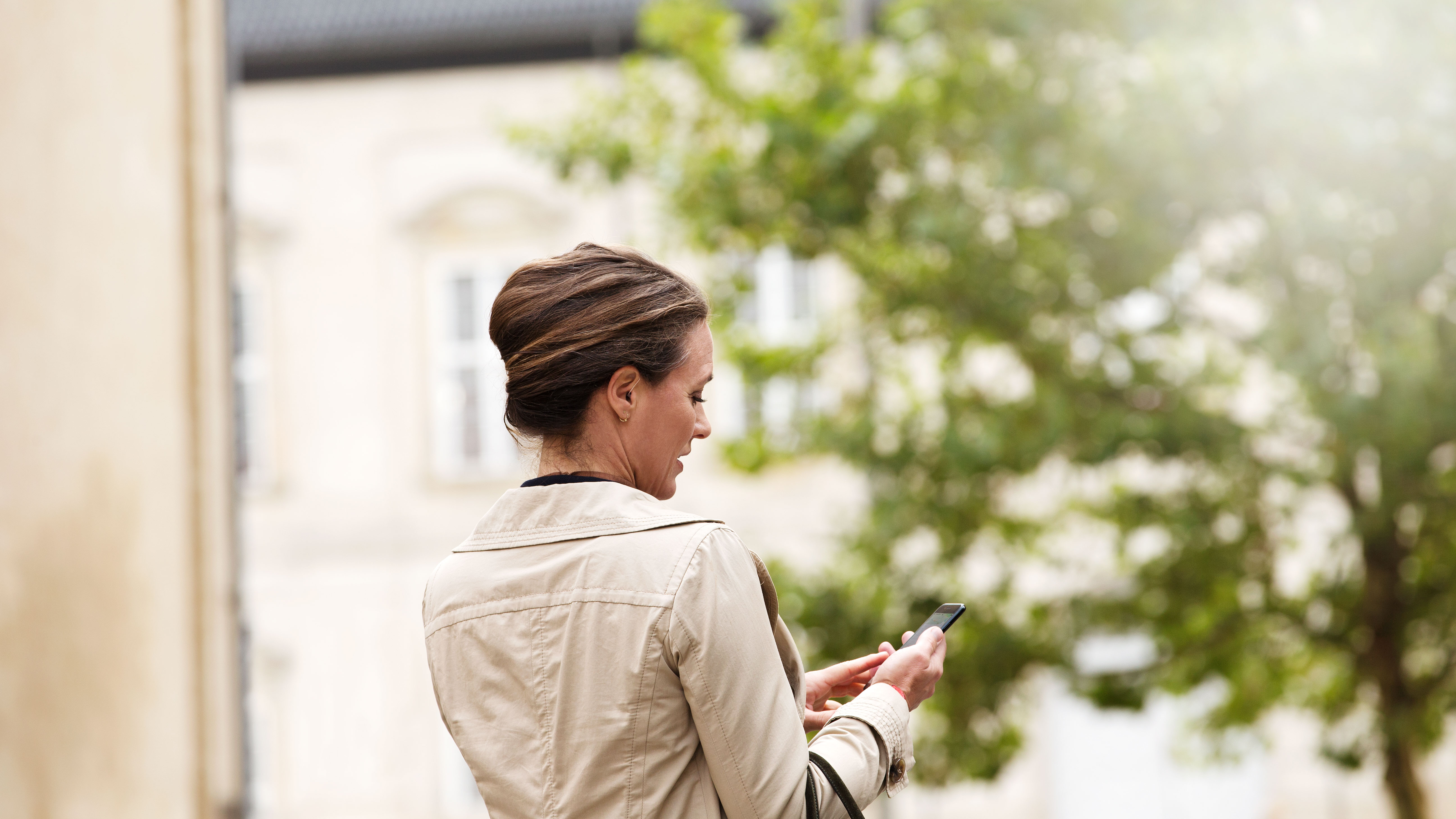 Woman on the phone, finding it hard to hear the person on the other end due to hearing loss