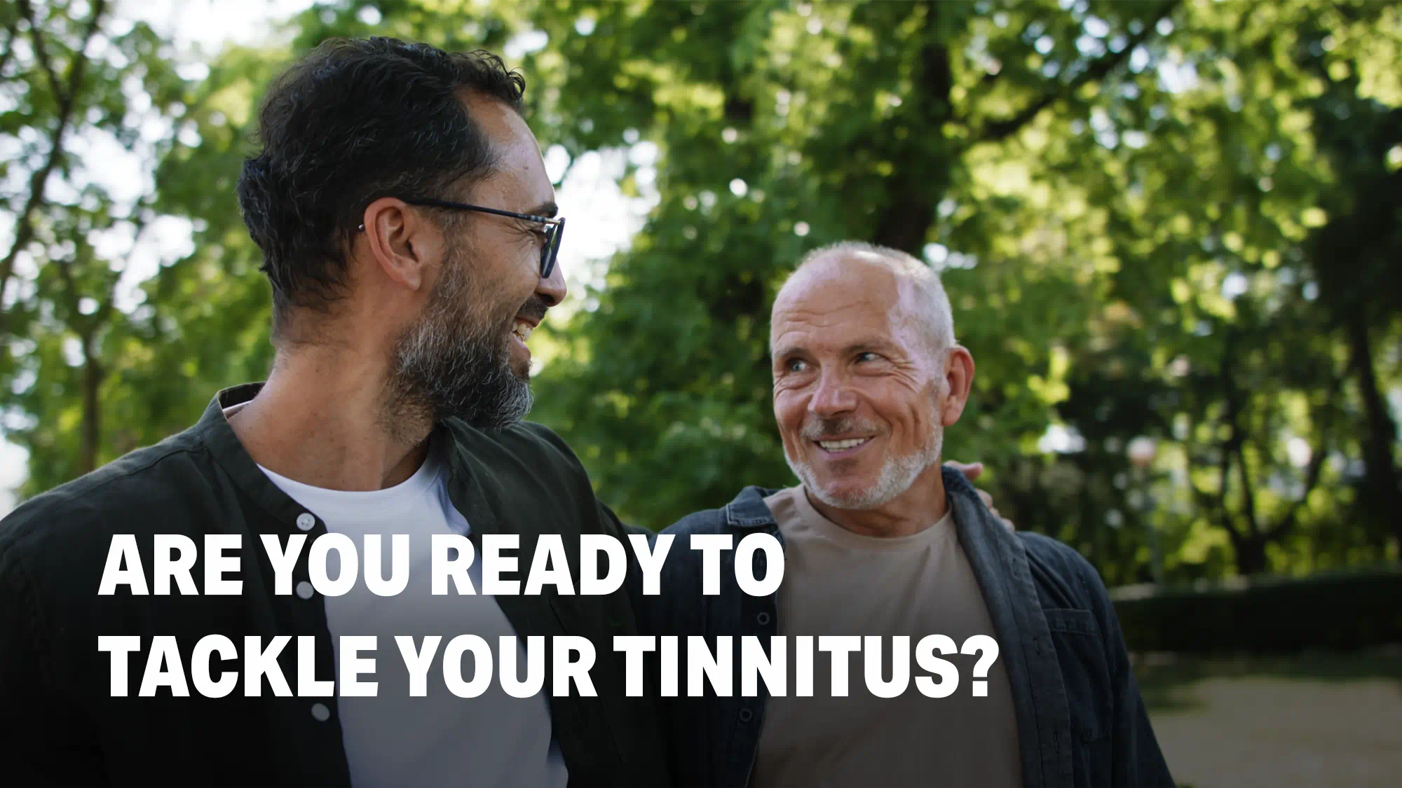 Men getting tinnitus relief with hearing aids, amplifying external sounds to mask internal ringing in the ears.