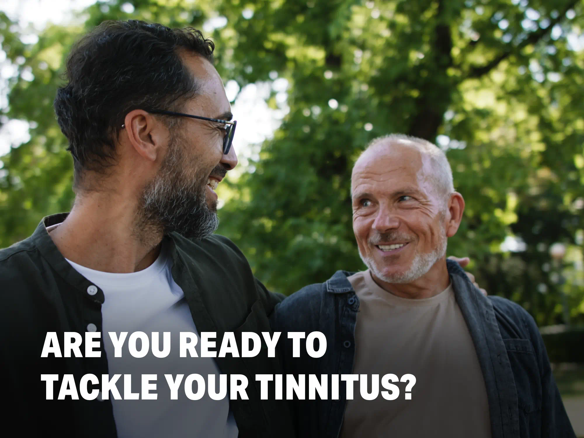 Men getting tinnitus relief with hearing aids, amplifying external sounds to mask internal ringing in the ears.