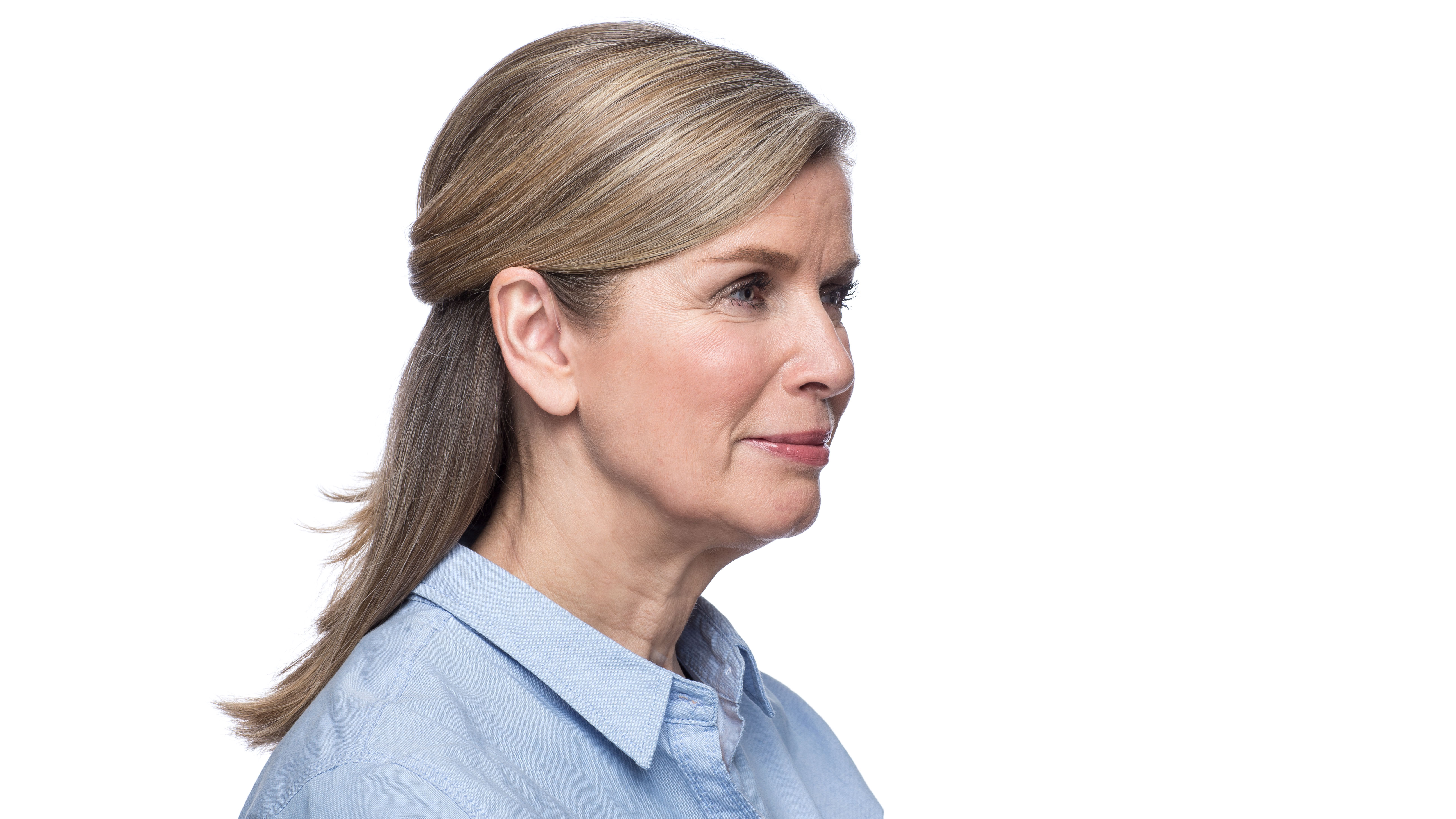 Woman wearing behind the ear hearing aid. 