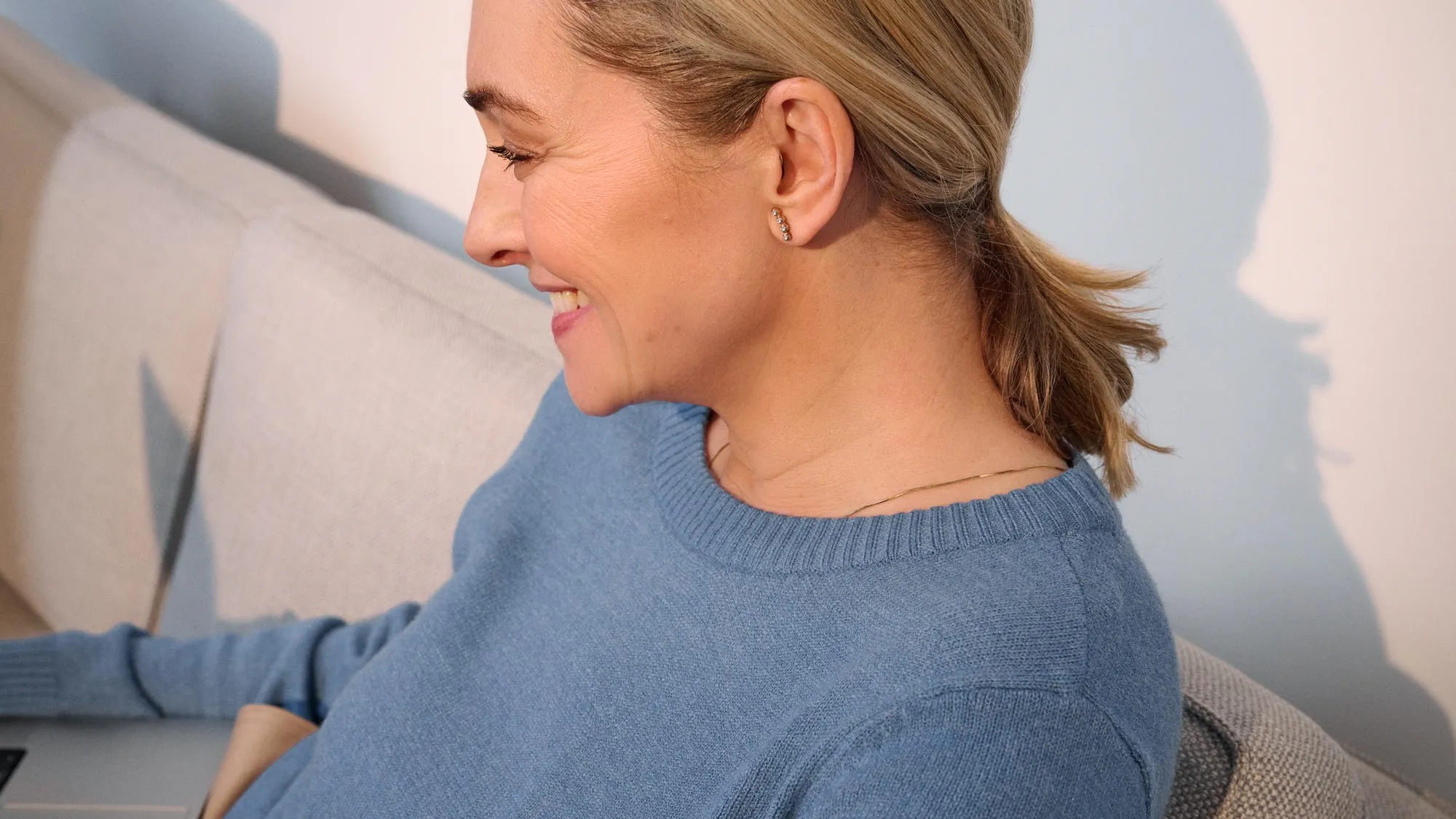Close-up of a casual woman wearing hearing aids.