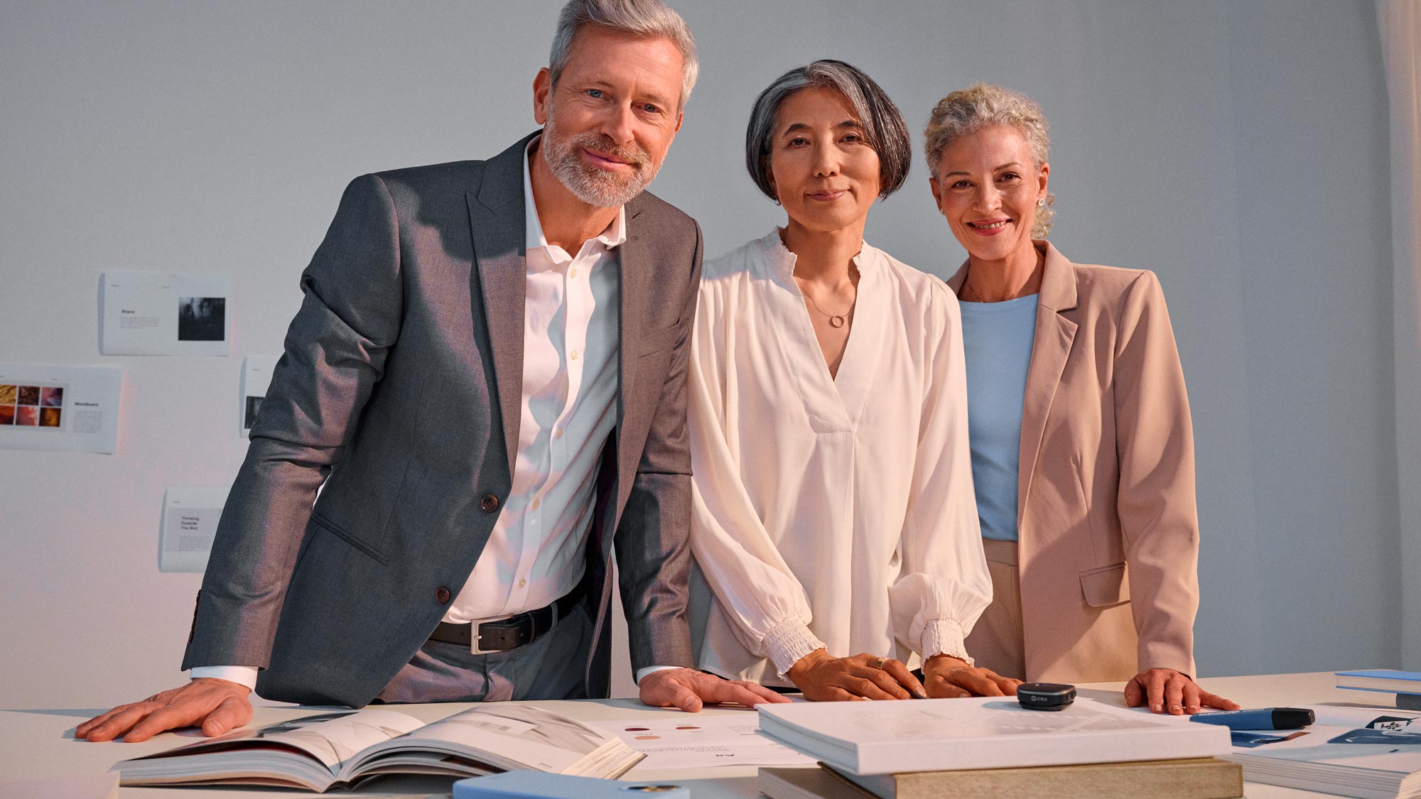 Business meeting scene, participants wearing hearing aids.