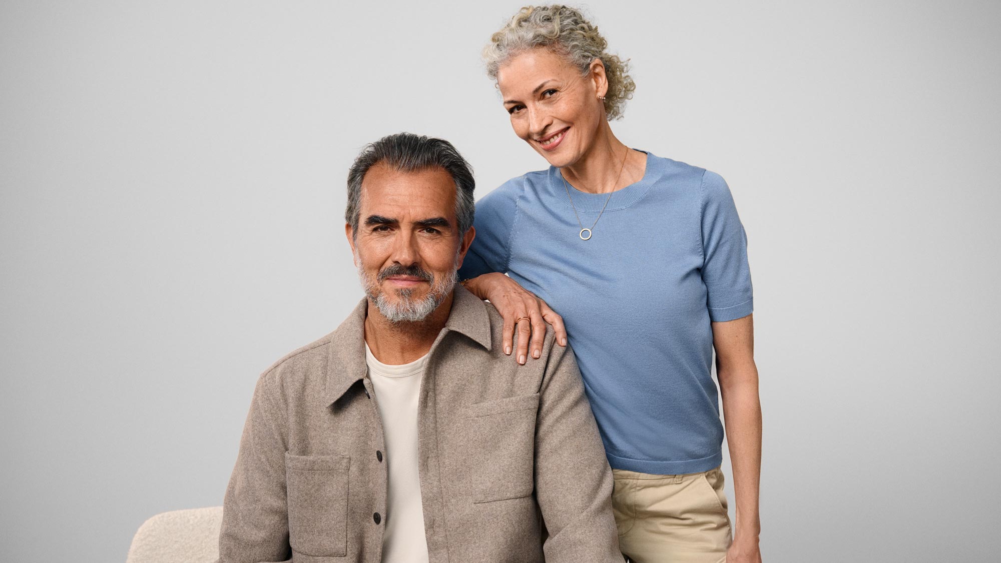 Couple standing together, indicating hearing improvement.