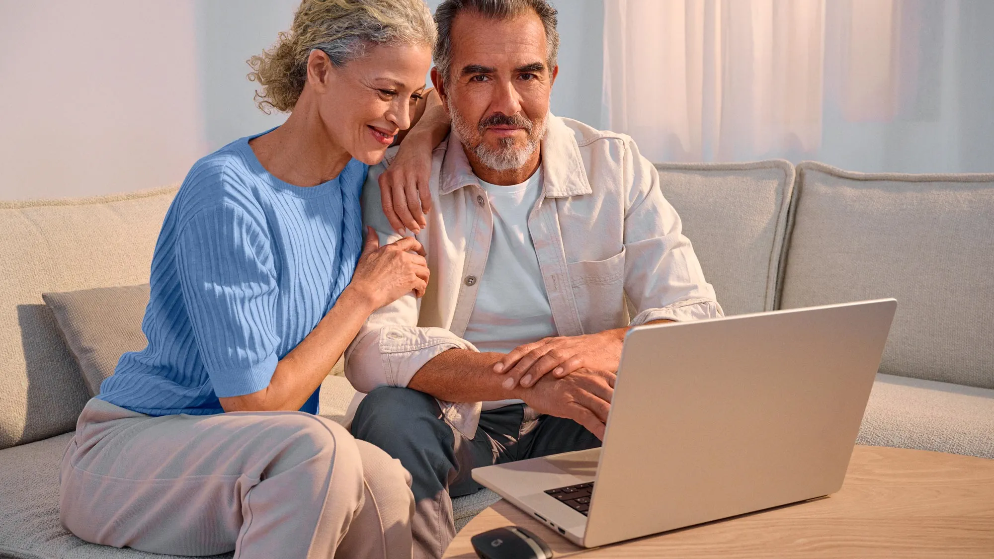 Confident couple using technology, highlighting hearing improvement.