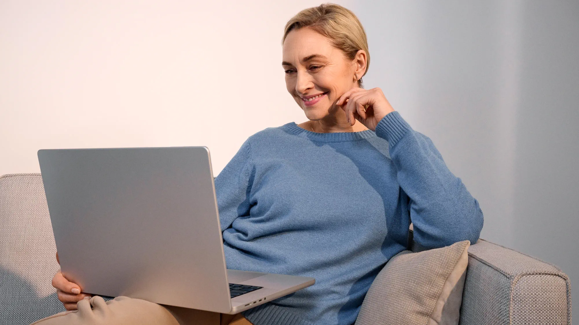 Woman researching on a computer, wearing hearing aids.