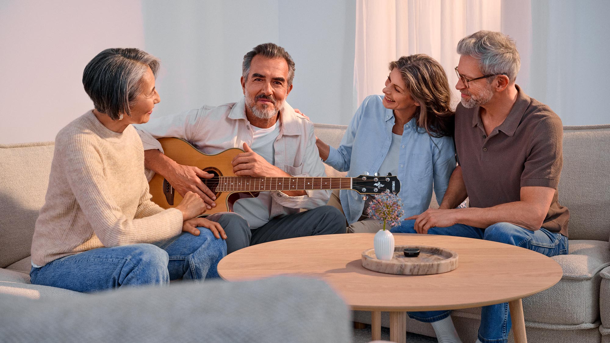 Friends playing guitar, showing hearing improvement.