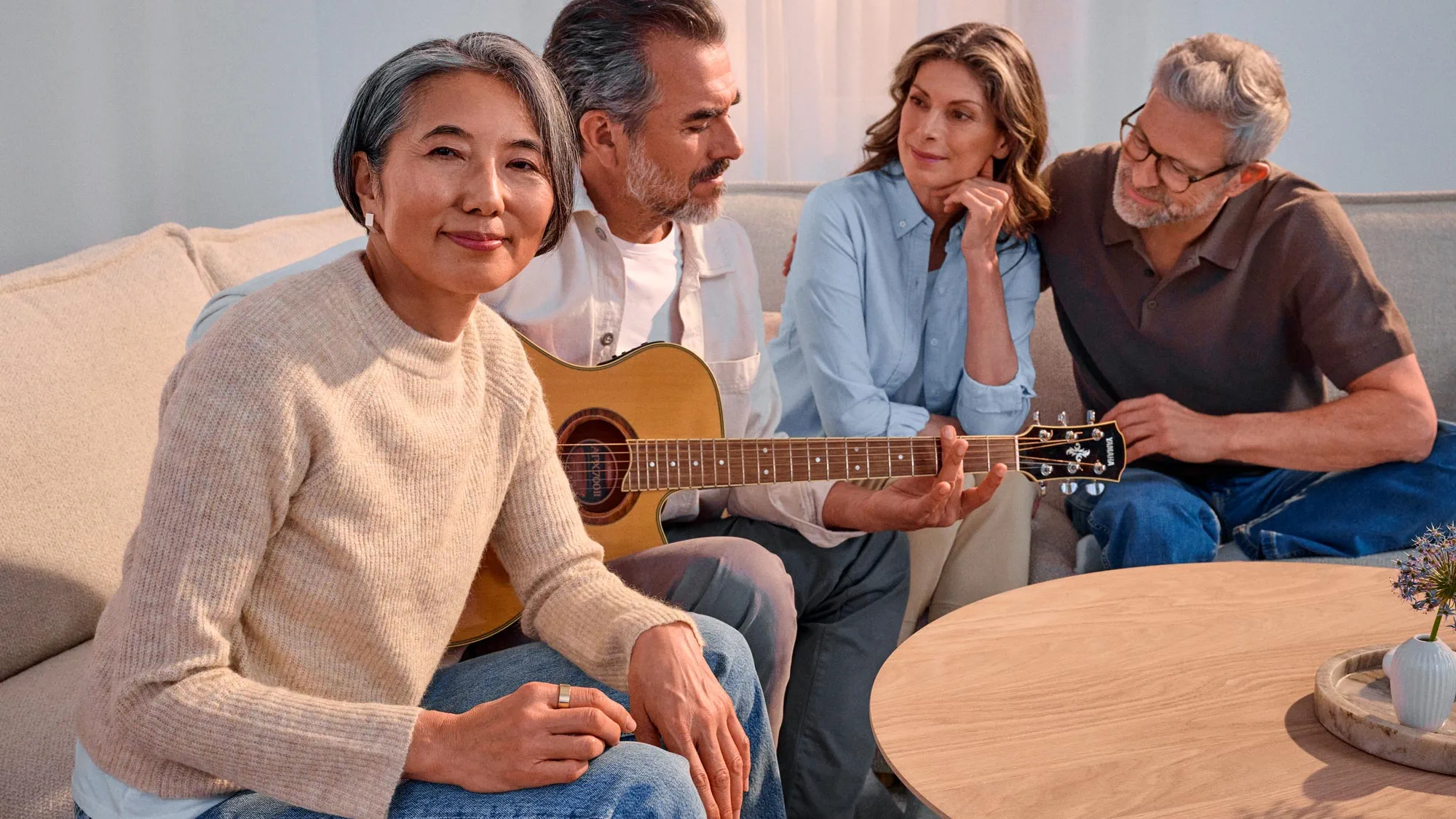 Friends playing guitar with a hopeful expression, highlighting hearing improvement.