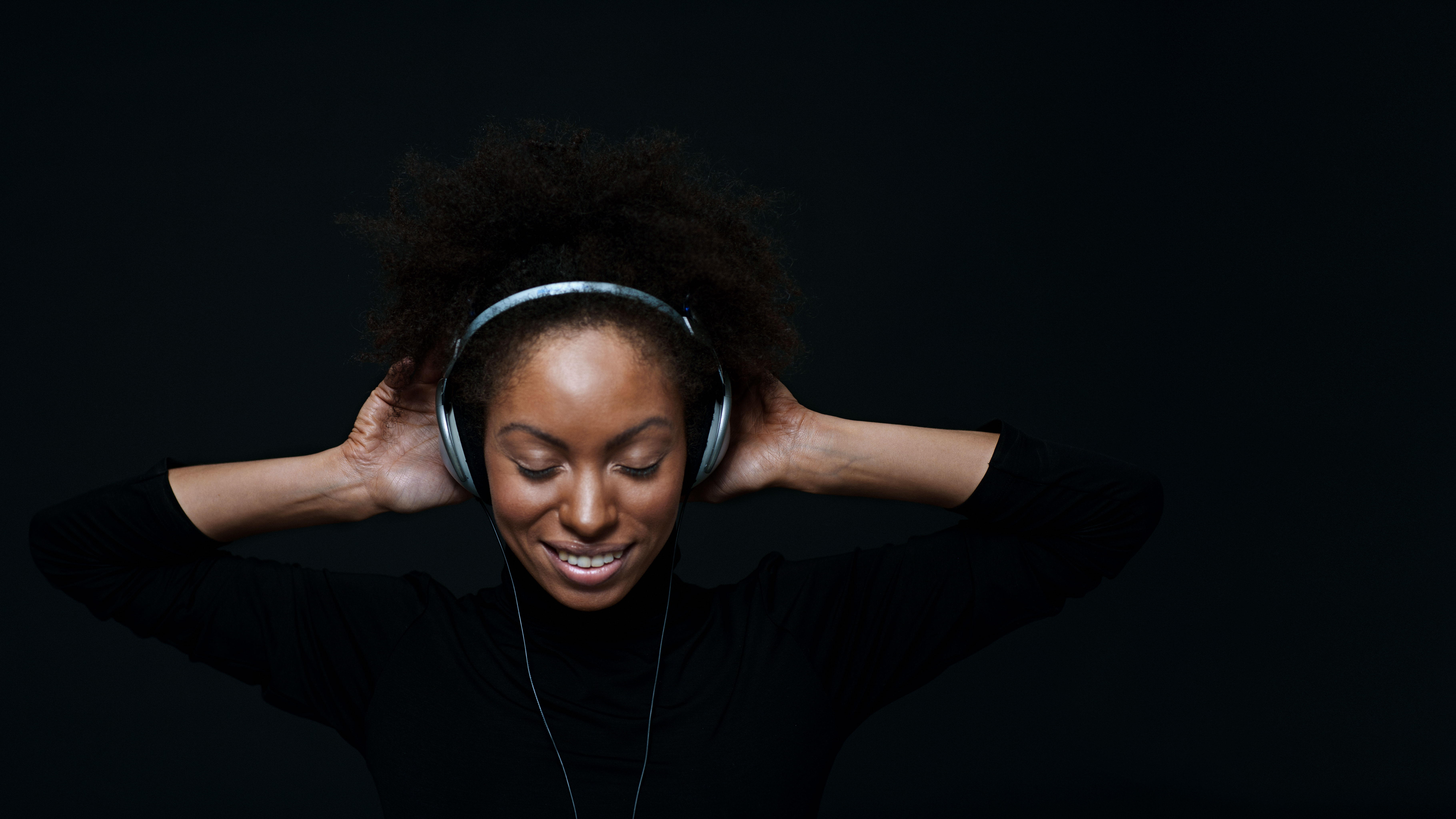 Woman listening to music risking hearing loss