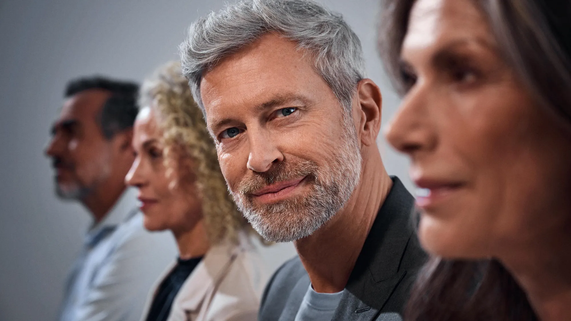 man-crowd-looking-hearing-aids-16x9