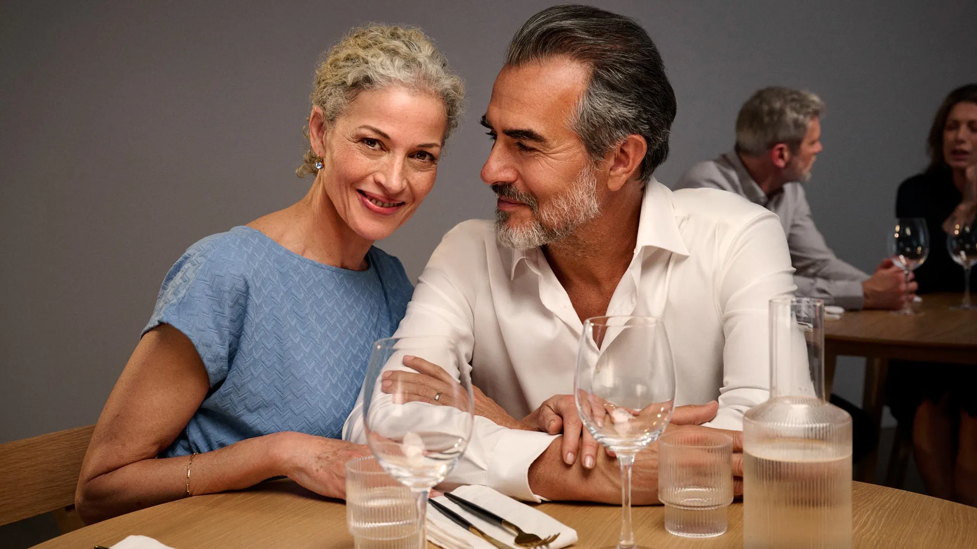 Woman looking at dinner, wearing hearing aids.