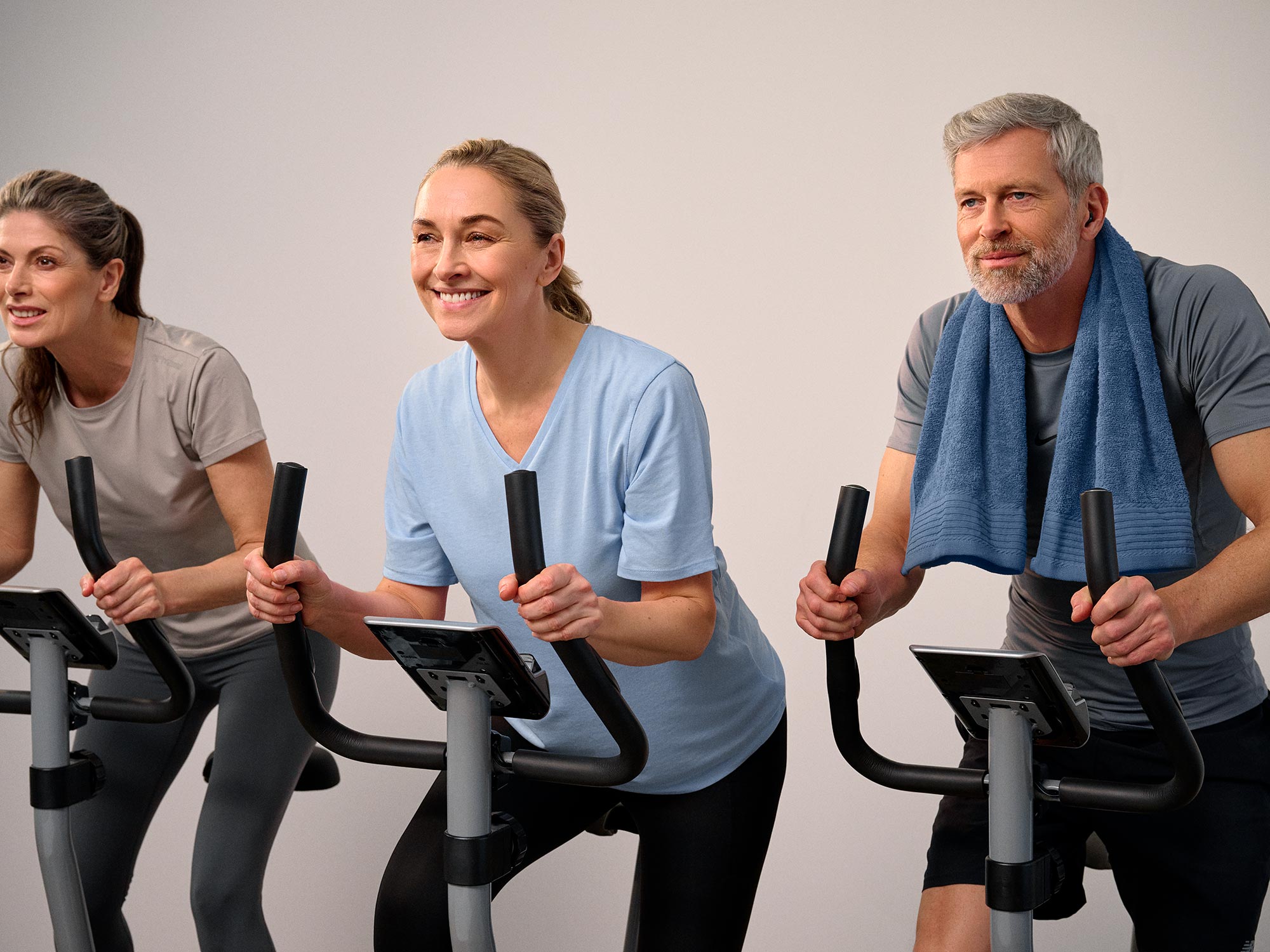 Group of friends in a biking class, all wearing hearing aids.
