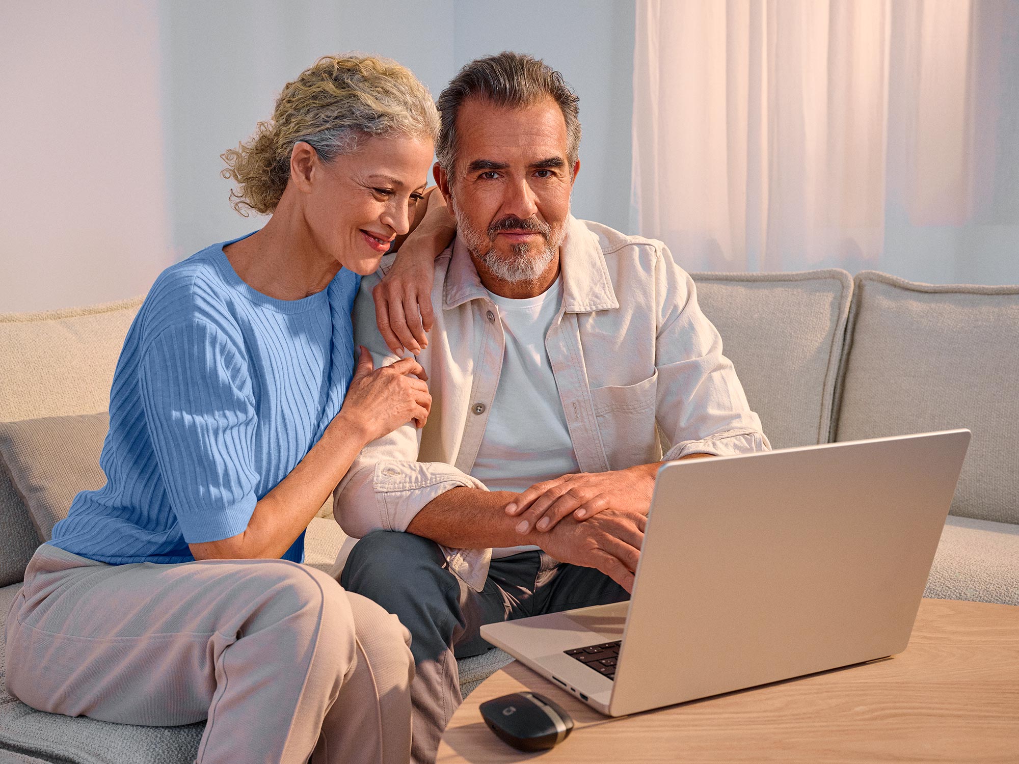 Confident couple using technology, highlighting hearing improvement.