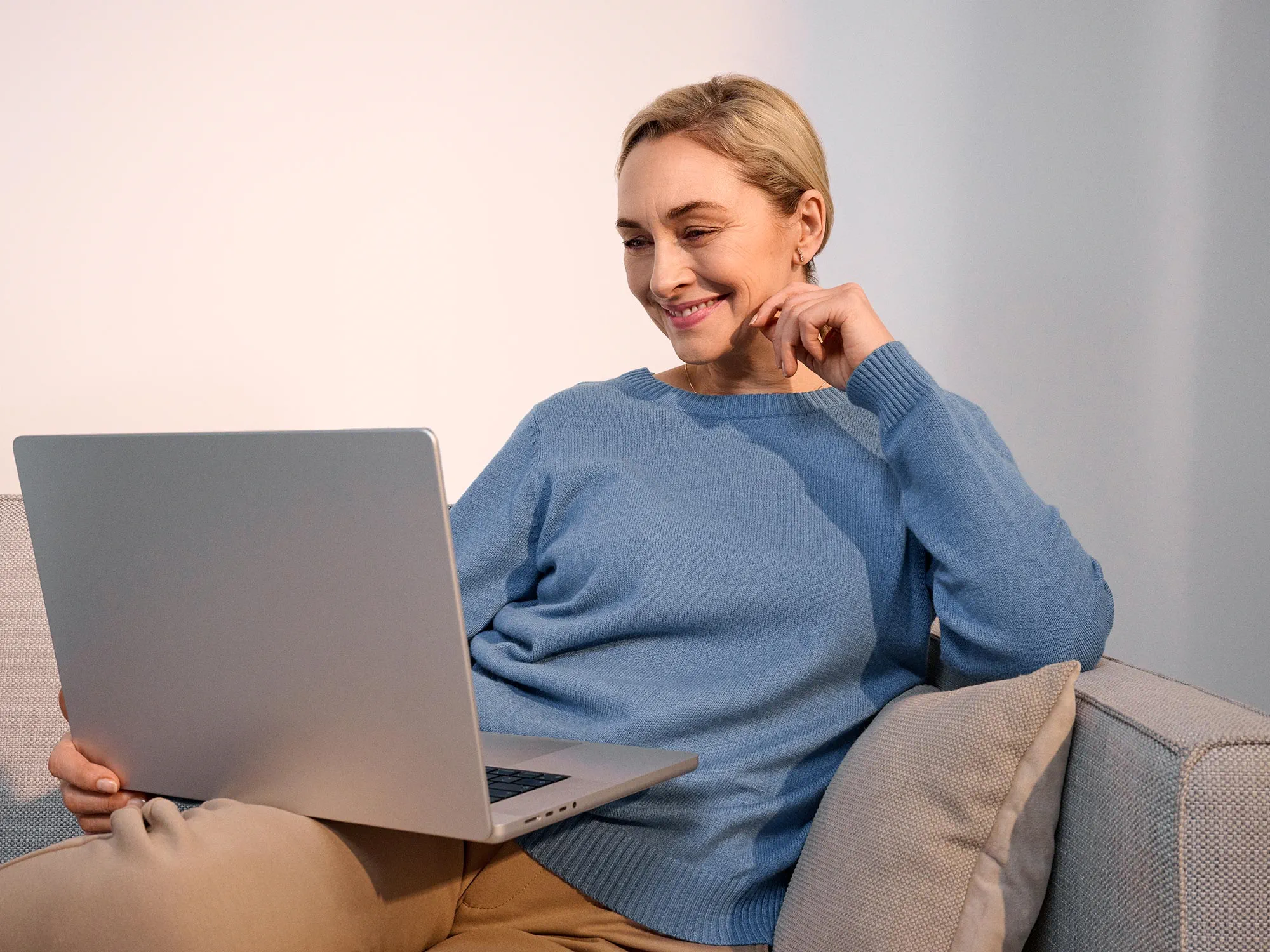 Woman researching on a computer, wearing hearing aids.