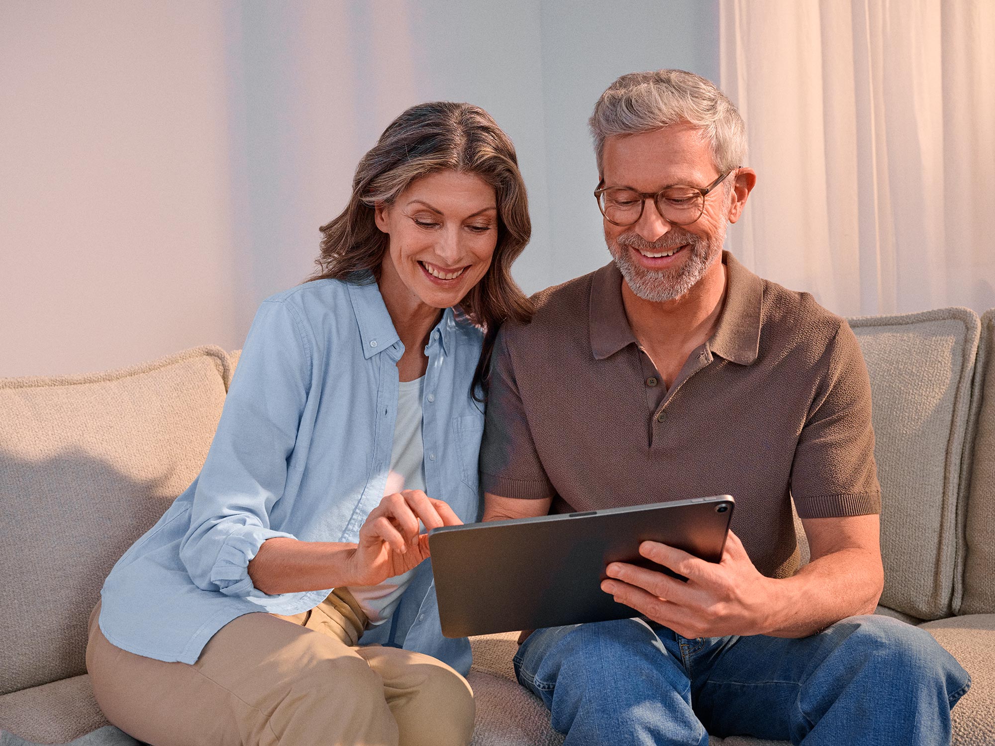 Enthusiastic couple using technology and benefiting from hearing improvement.