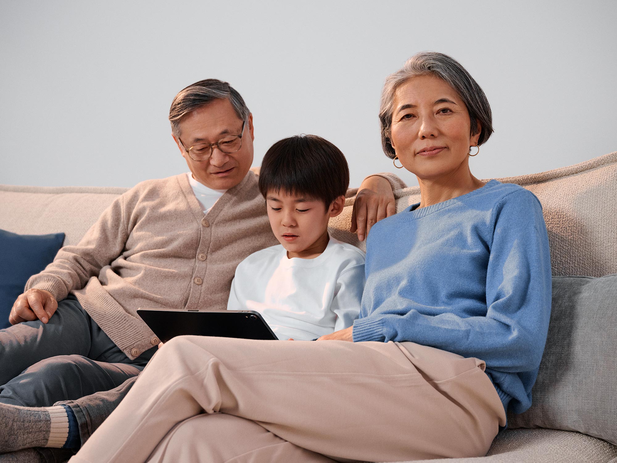 Grandparents and boy discussing technology and hearing loss.