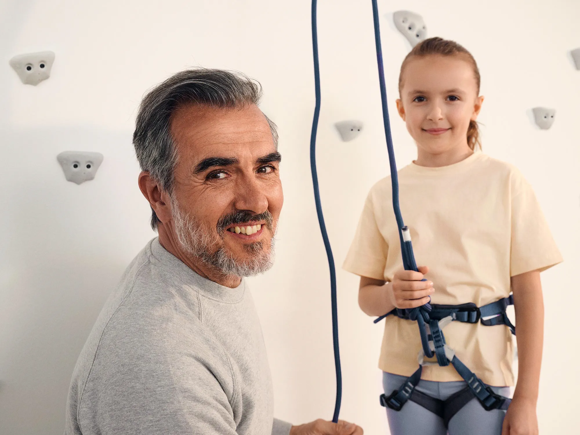 Grandparent and girl smiling, showcasing hearing aids.