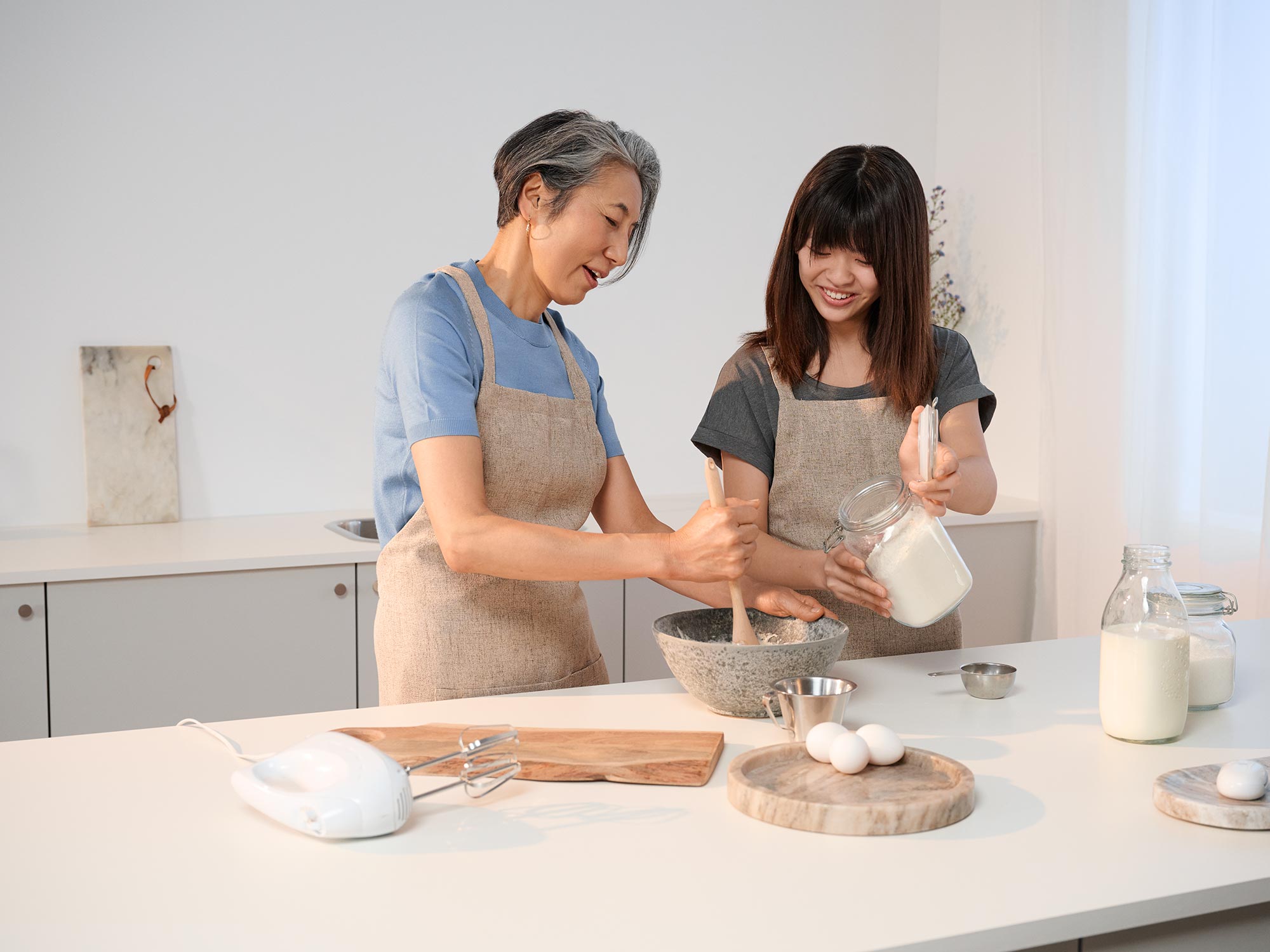 Grandmother cooking in the kitchen, wearing hearing aids.