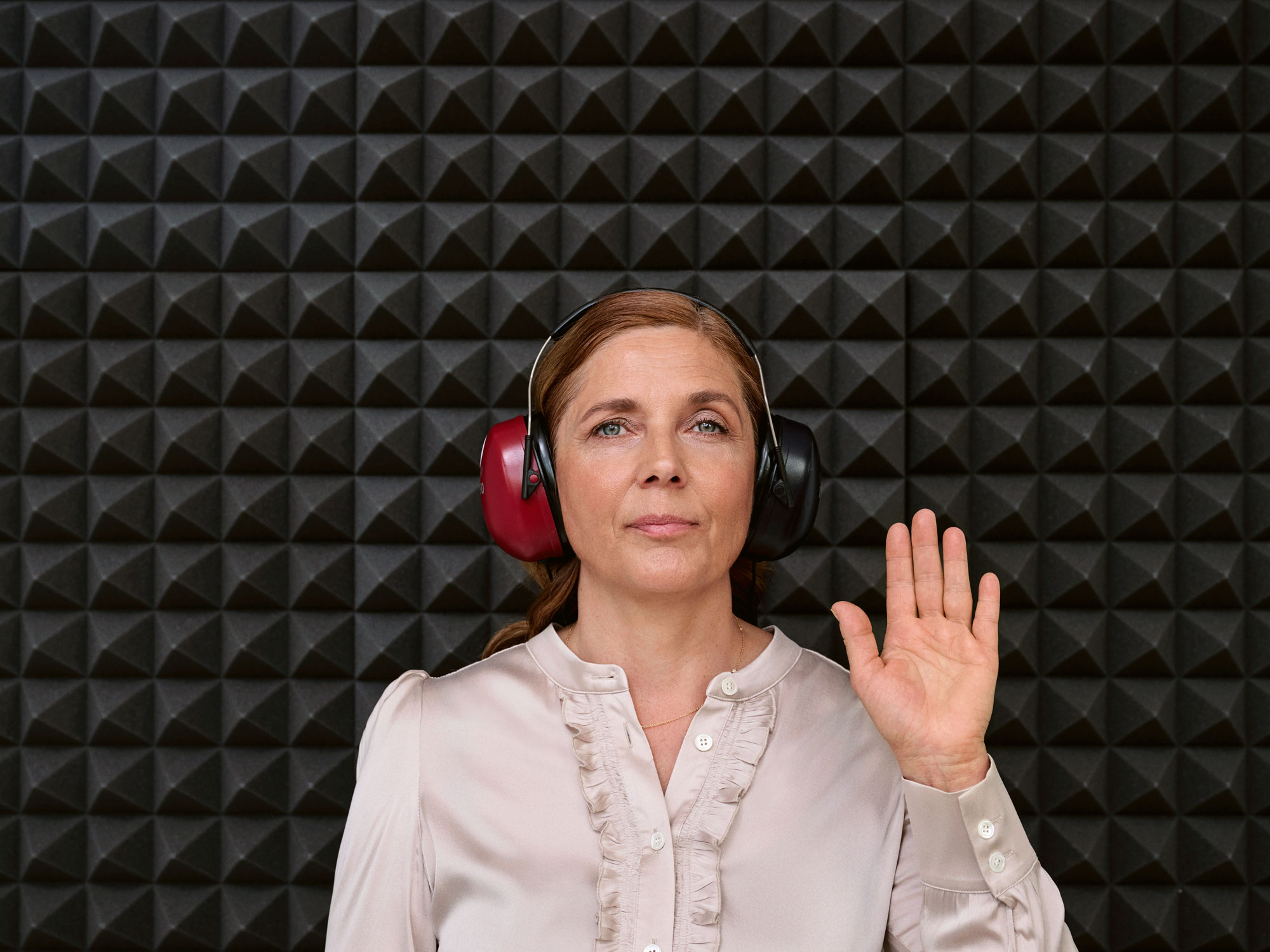 A customer getting a hearing test inside a sound booth during a hearing appointment.