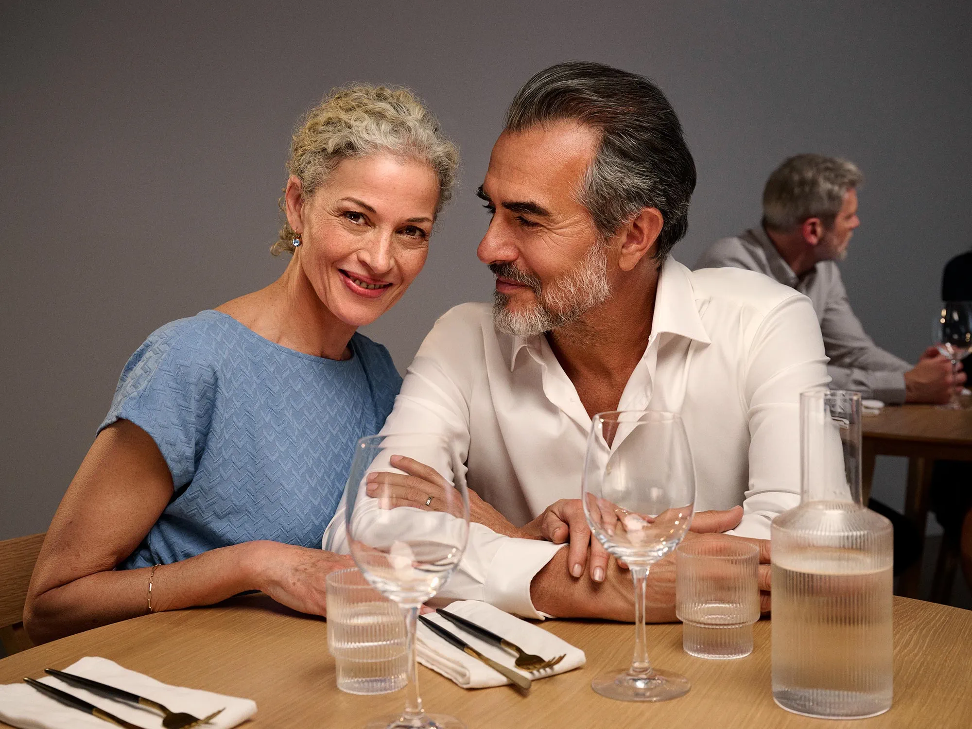 Woman looking at dinner, wearing hearing aids.
