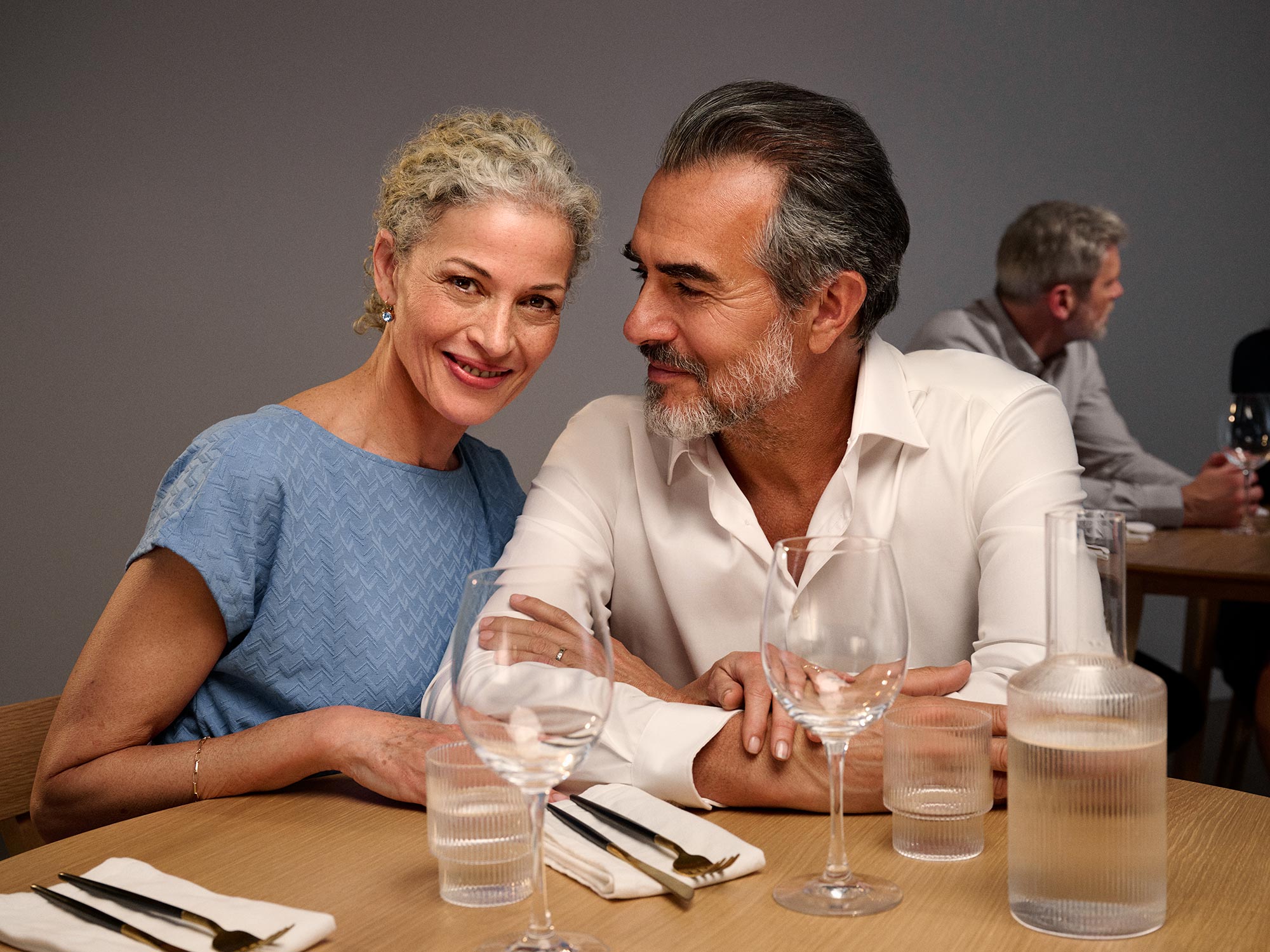 Woman looking at dinner, wearing hearing aids.