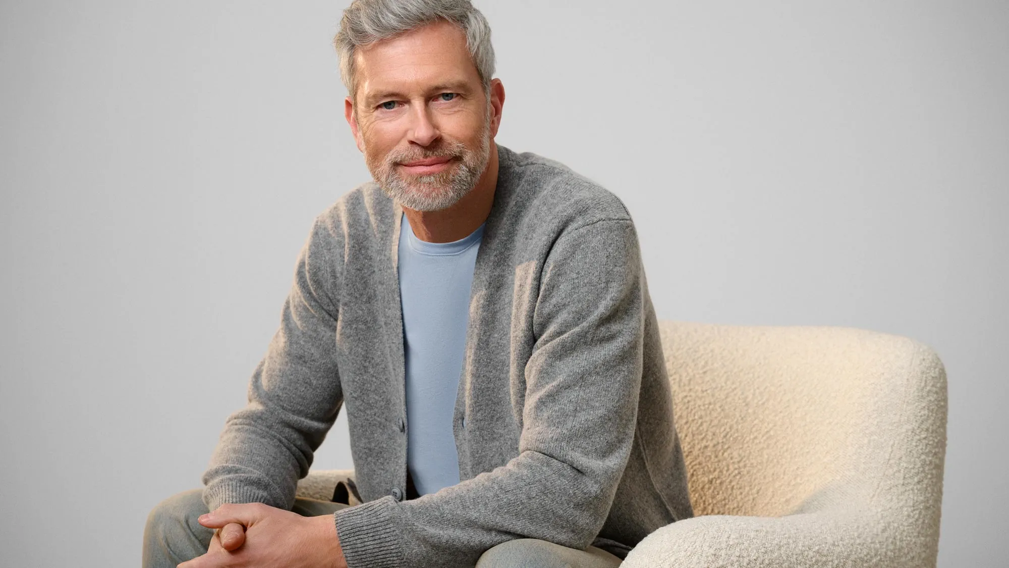 Calm man staring, reflecting on hearing loss.