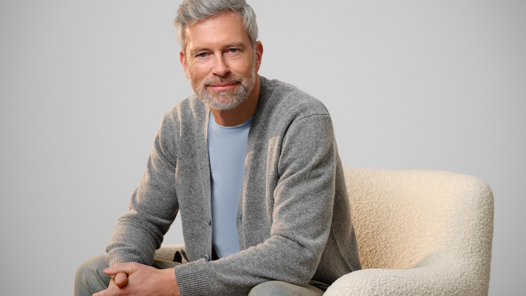 Calm man staring, reflecting on hearing loss.