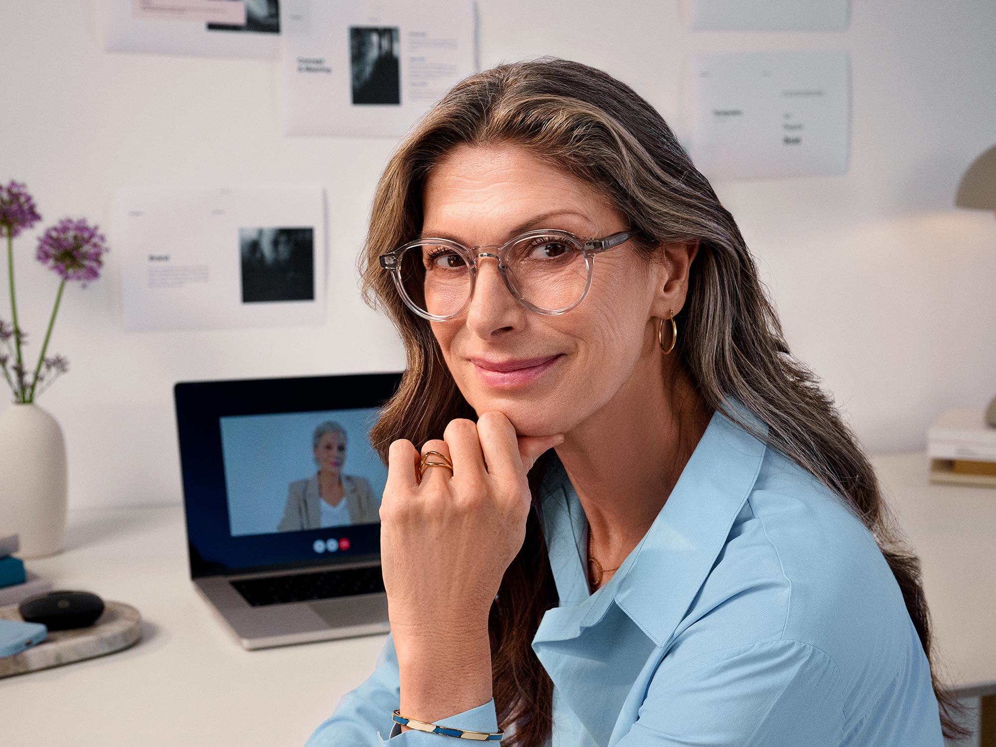 Woman contentedly working, showcasing hearing aids.