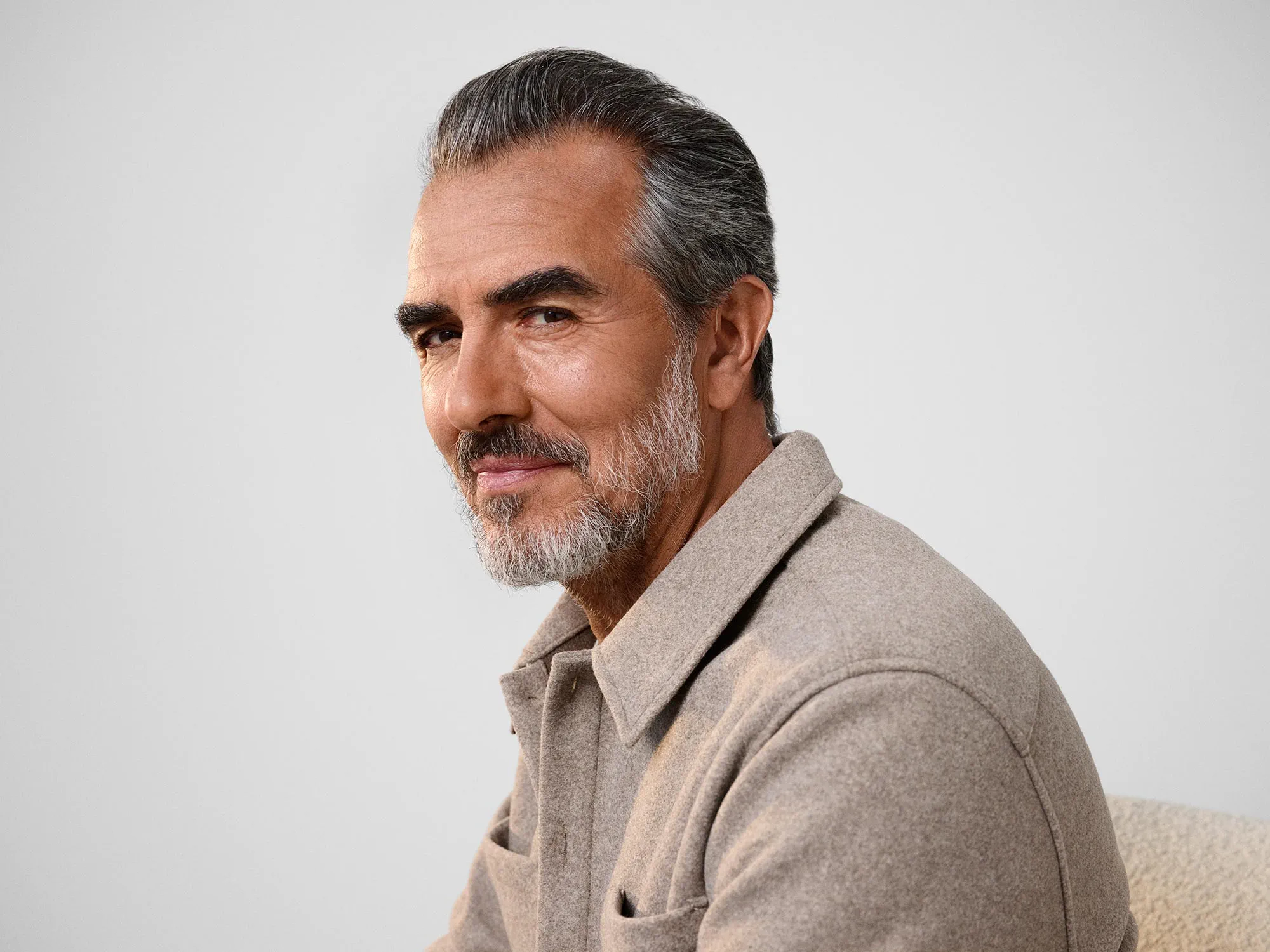 Man glancing, wearing hearing aids.