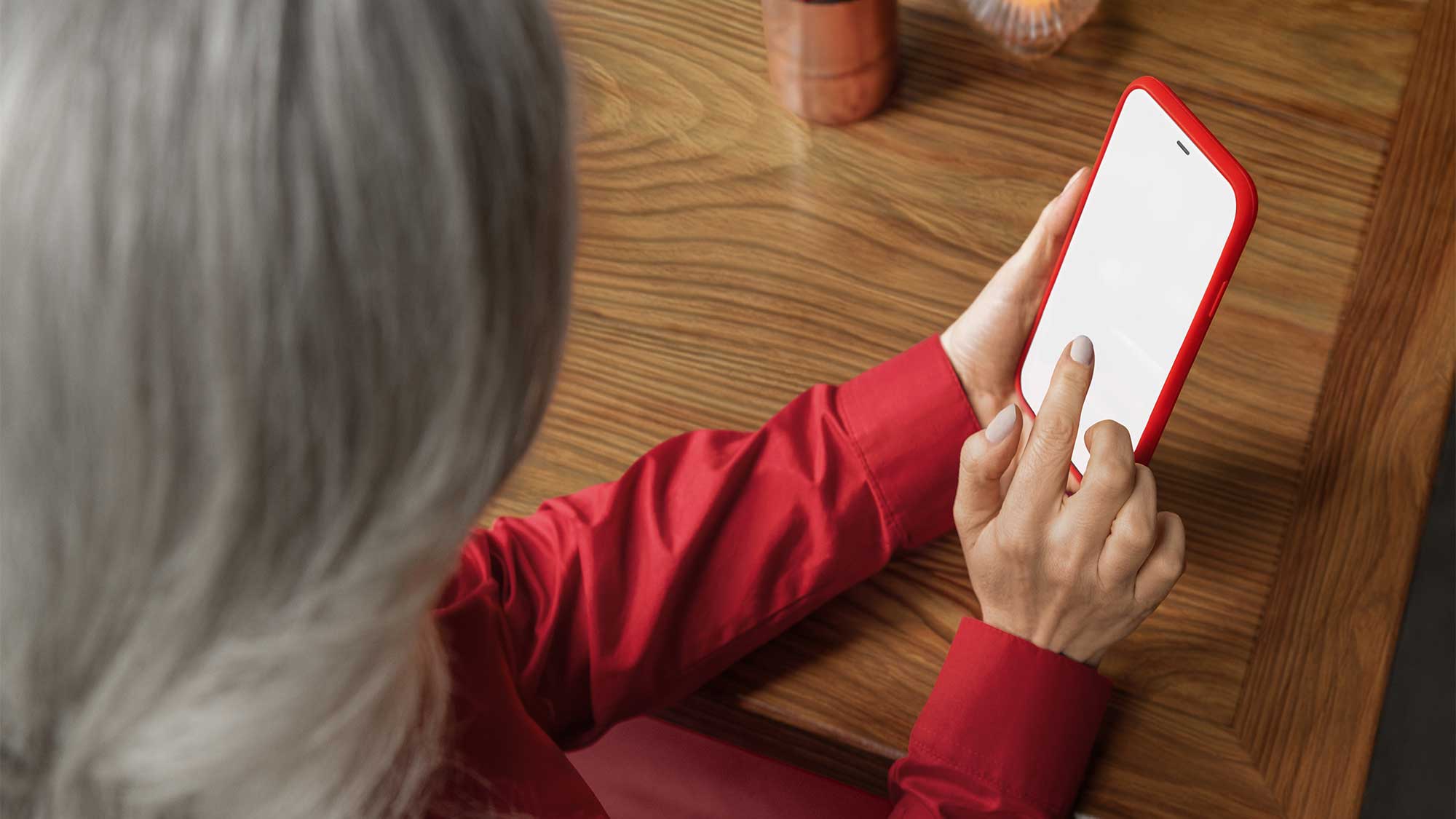 A woman using a phone while wearing Signia hearing aids, showcasing connectivity and hearing-loss support.