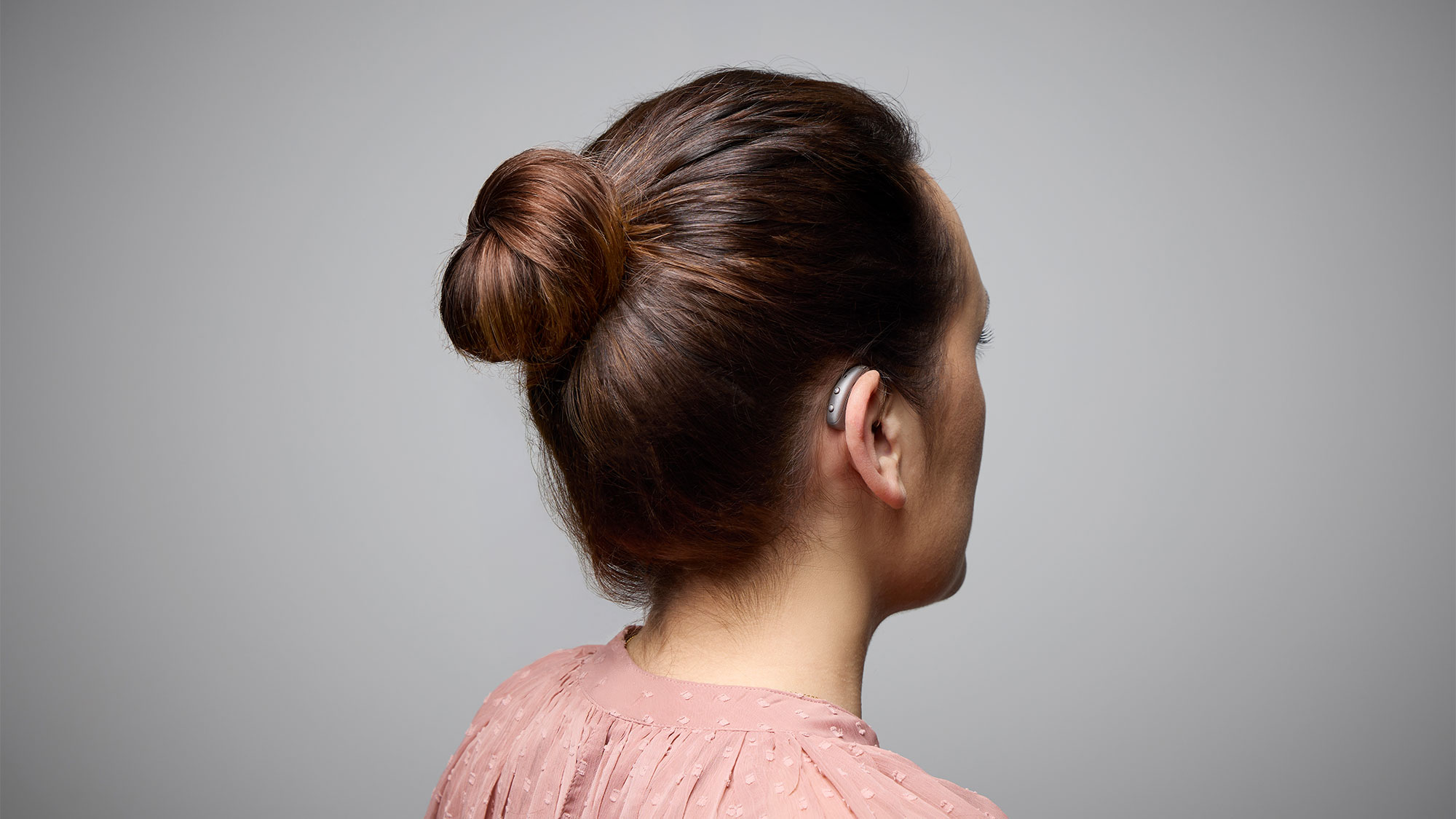 Back view of Signia Pure Charge&Go Max hearing aids worn on ears, offering discreet support for hearing-loss.