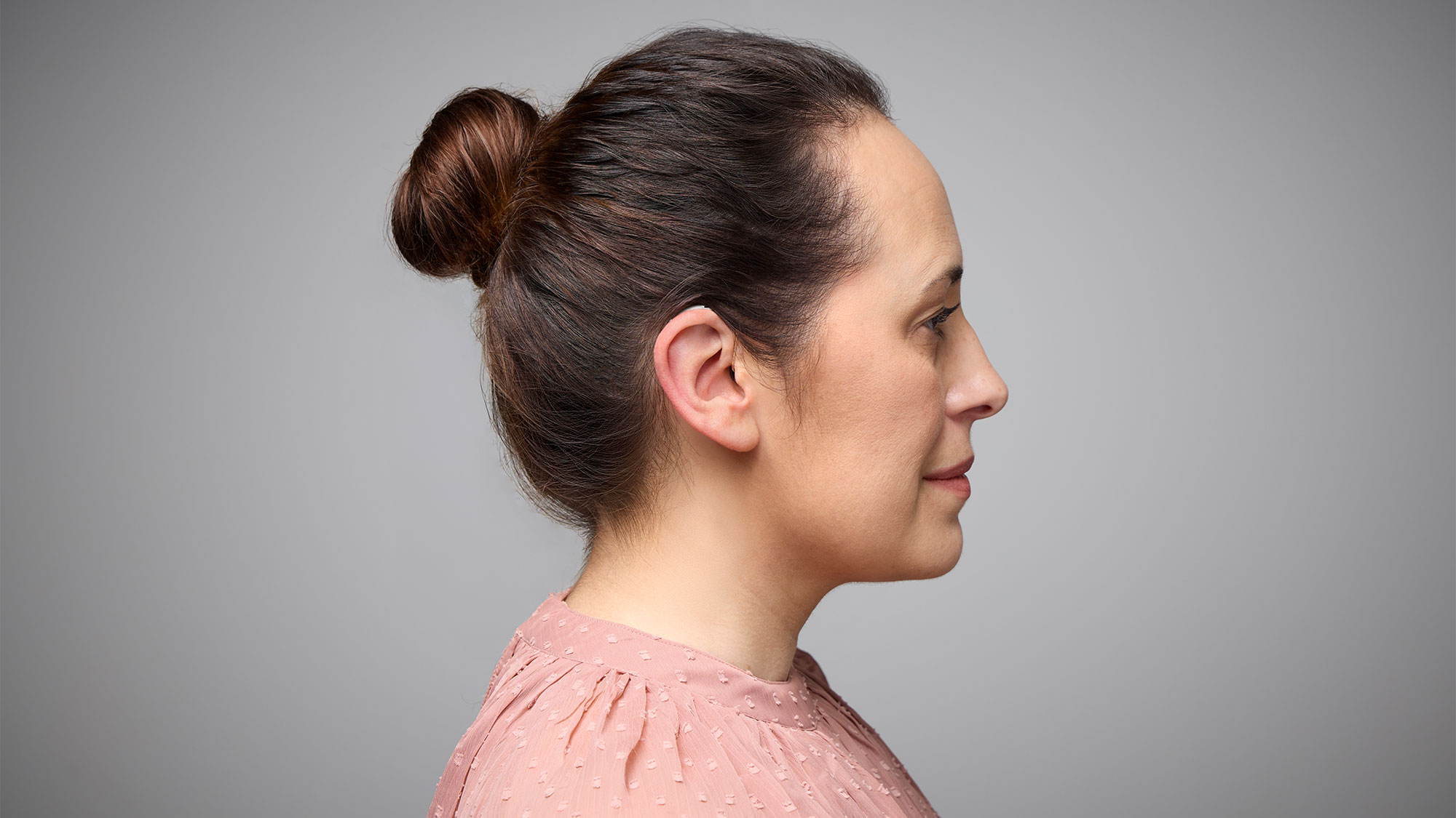 Side view of Signia Pure Charge&Go Max hearing aids worn on ears, delivering discreet assistance for hearing-loss.