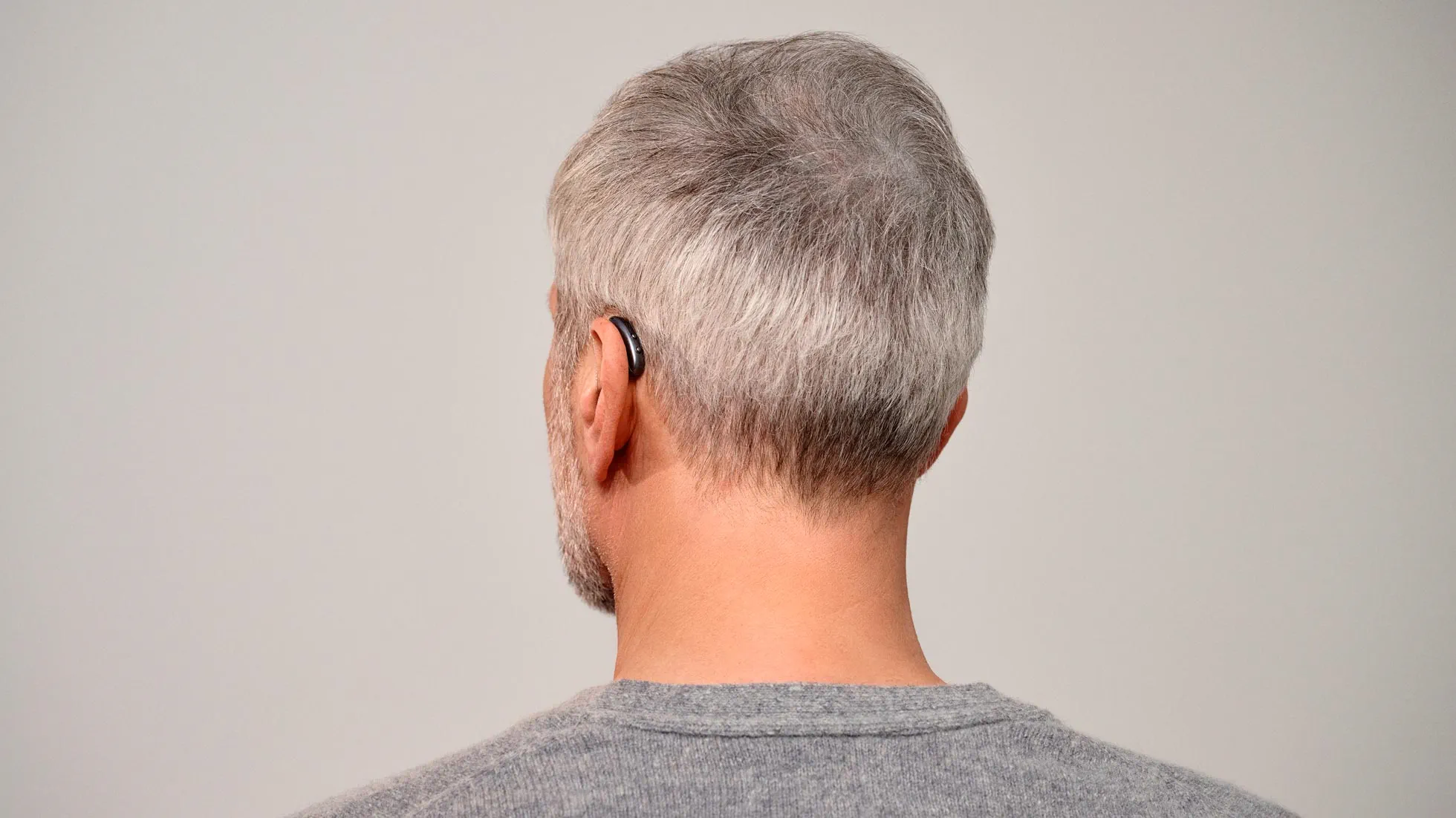 Seeing man from behind wearing nearly invisible Signia Pure hearing aids