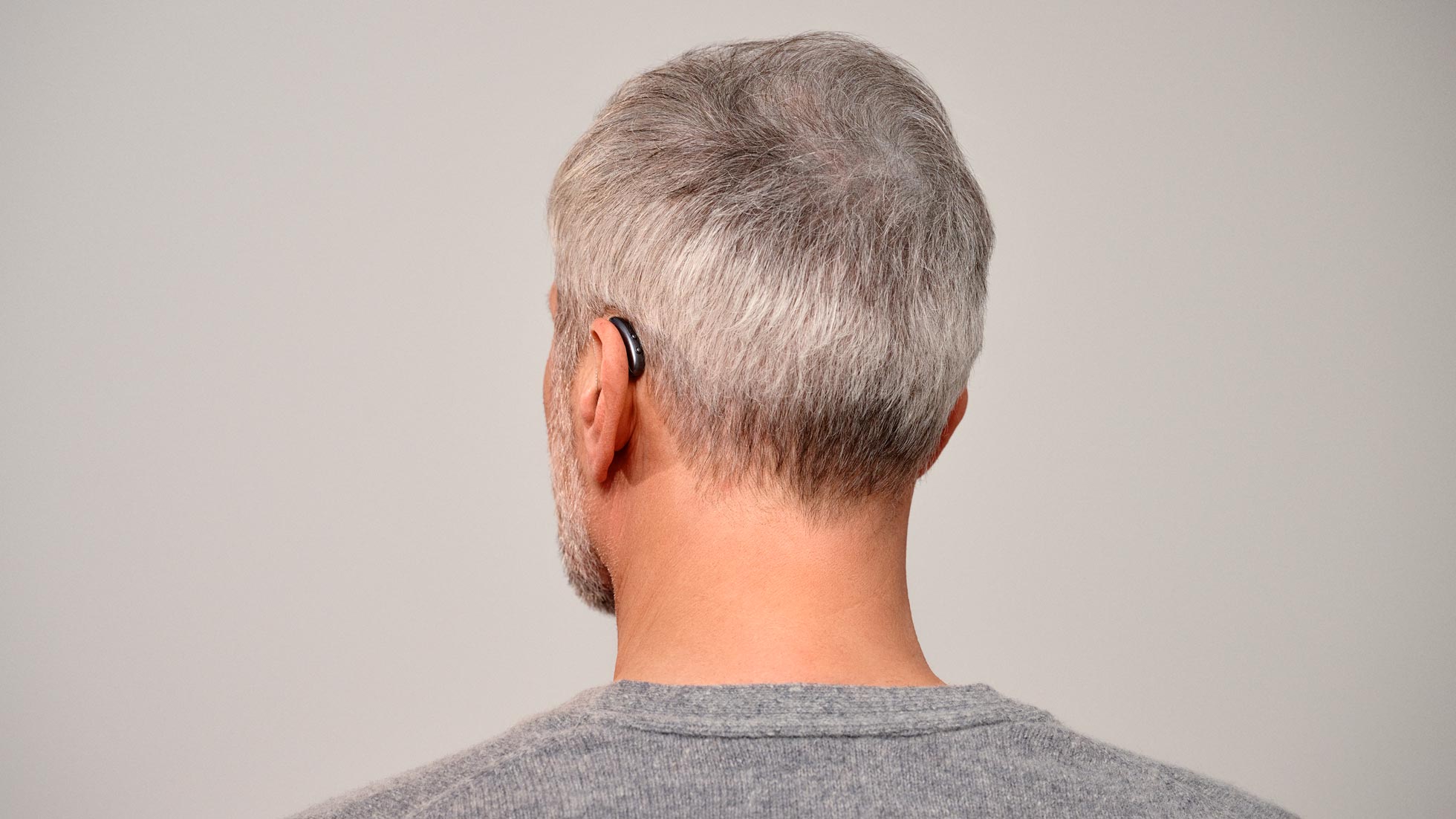 Seeing man from behind wearing nearly invisible Signia Pure hearing aids