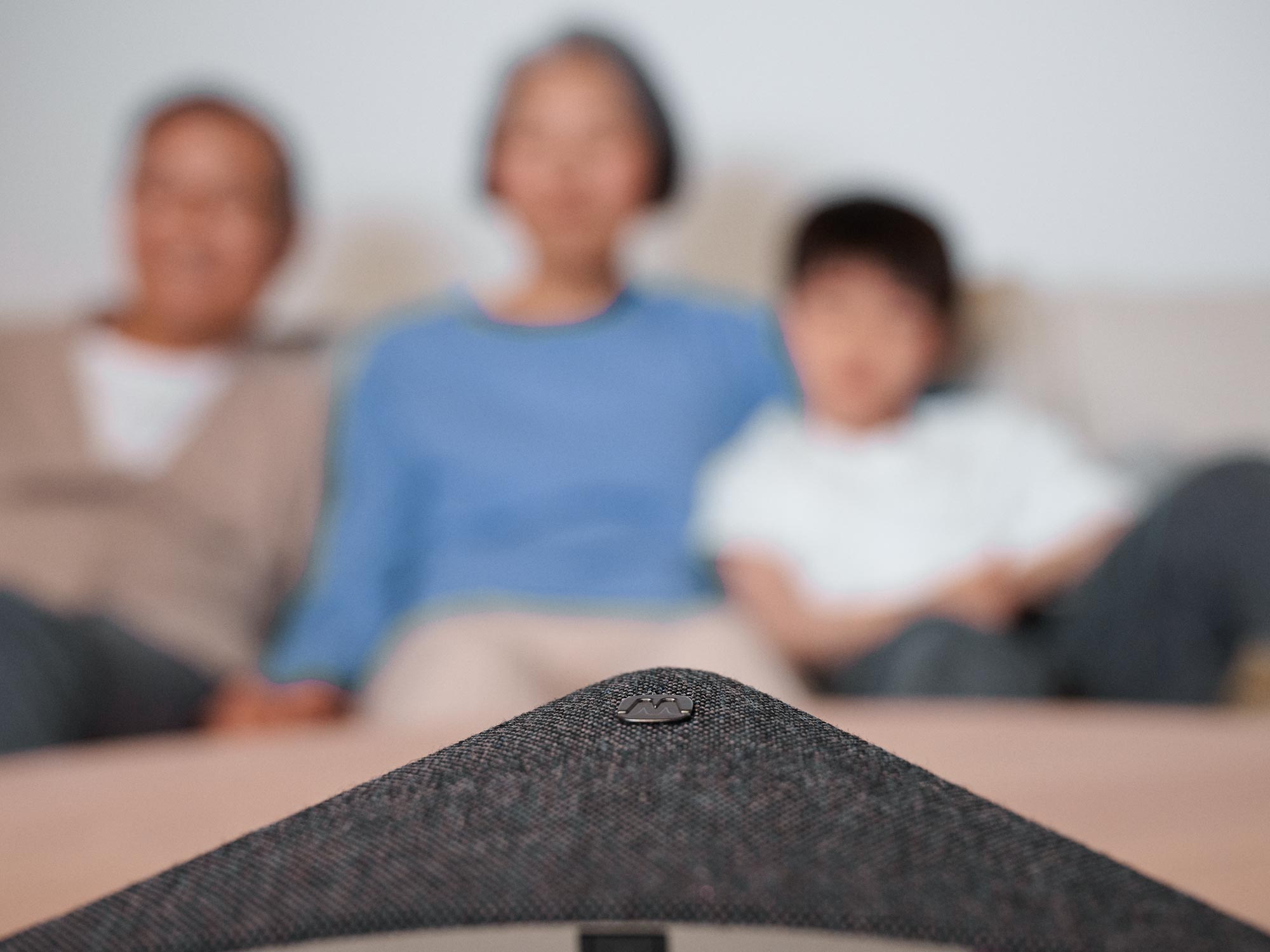 Grandparents enjoying TV, using Widex TVPlay accessory.