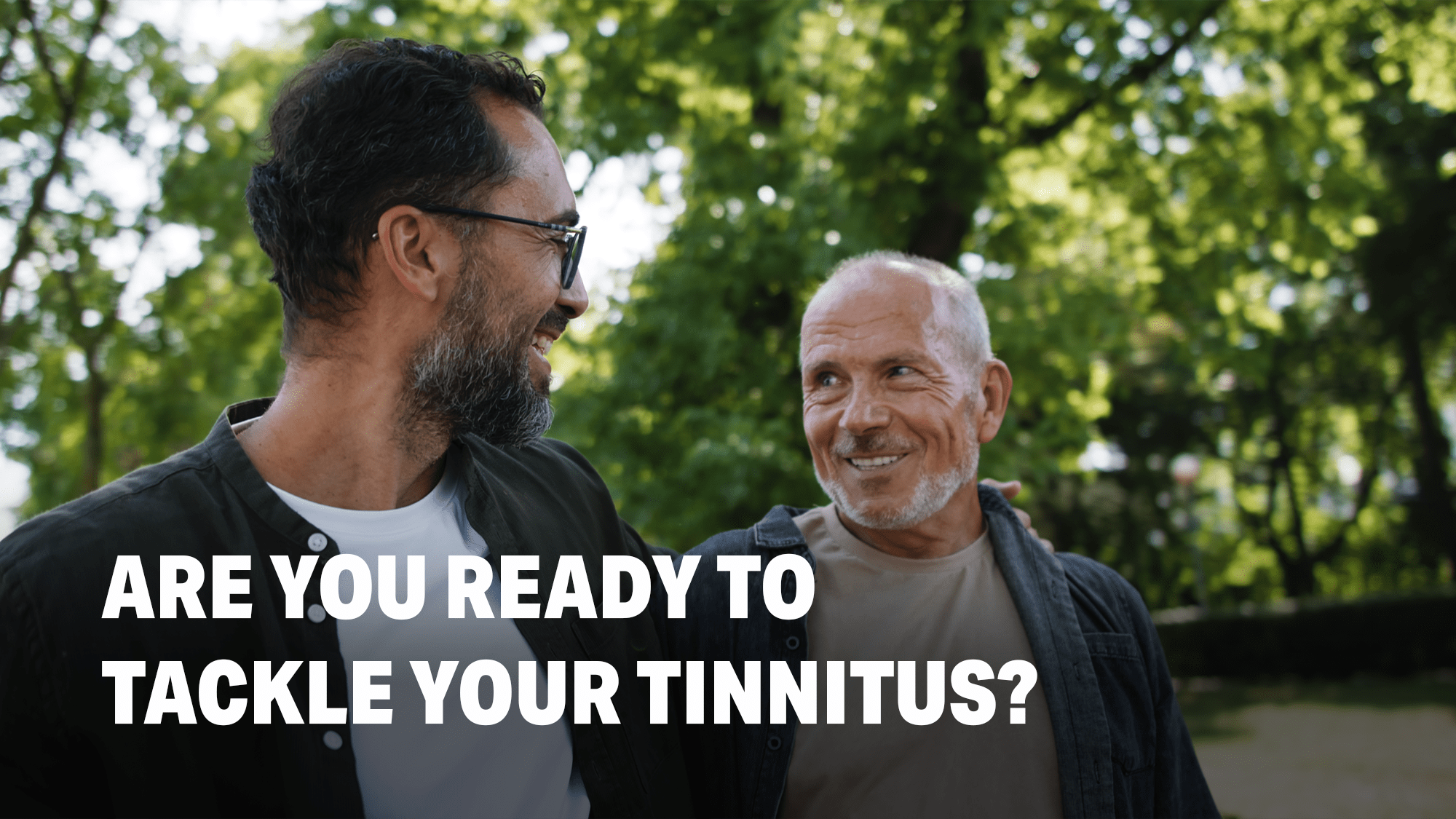 Men getting tinnitus relief with hearing aids, amplifying external sounds to mask internal ringing in the ears.