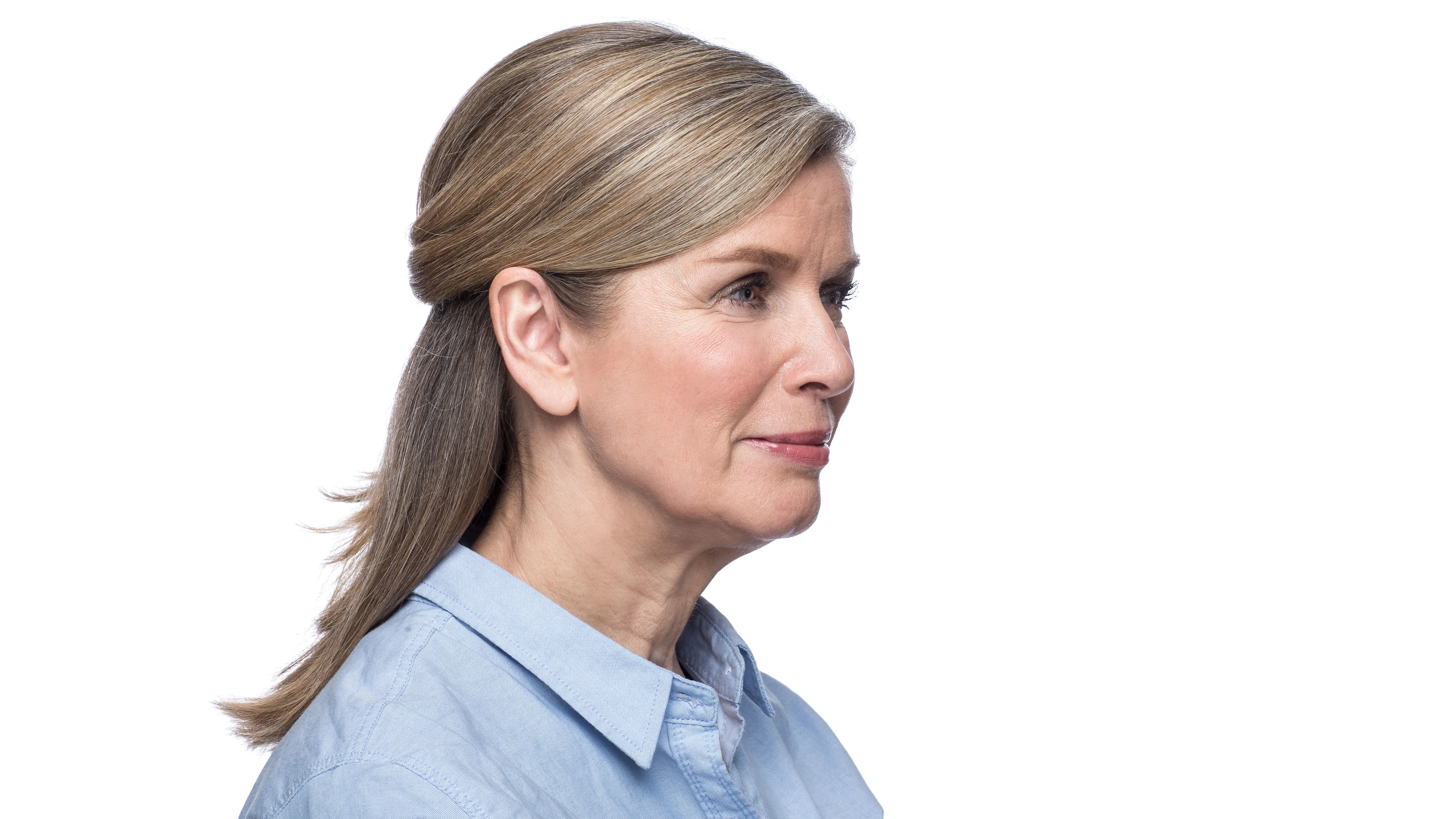 Woman wearing behind the ear hearing aid. 