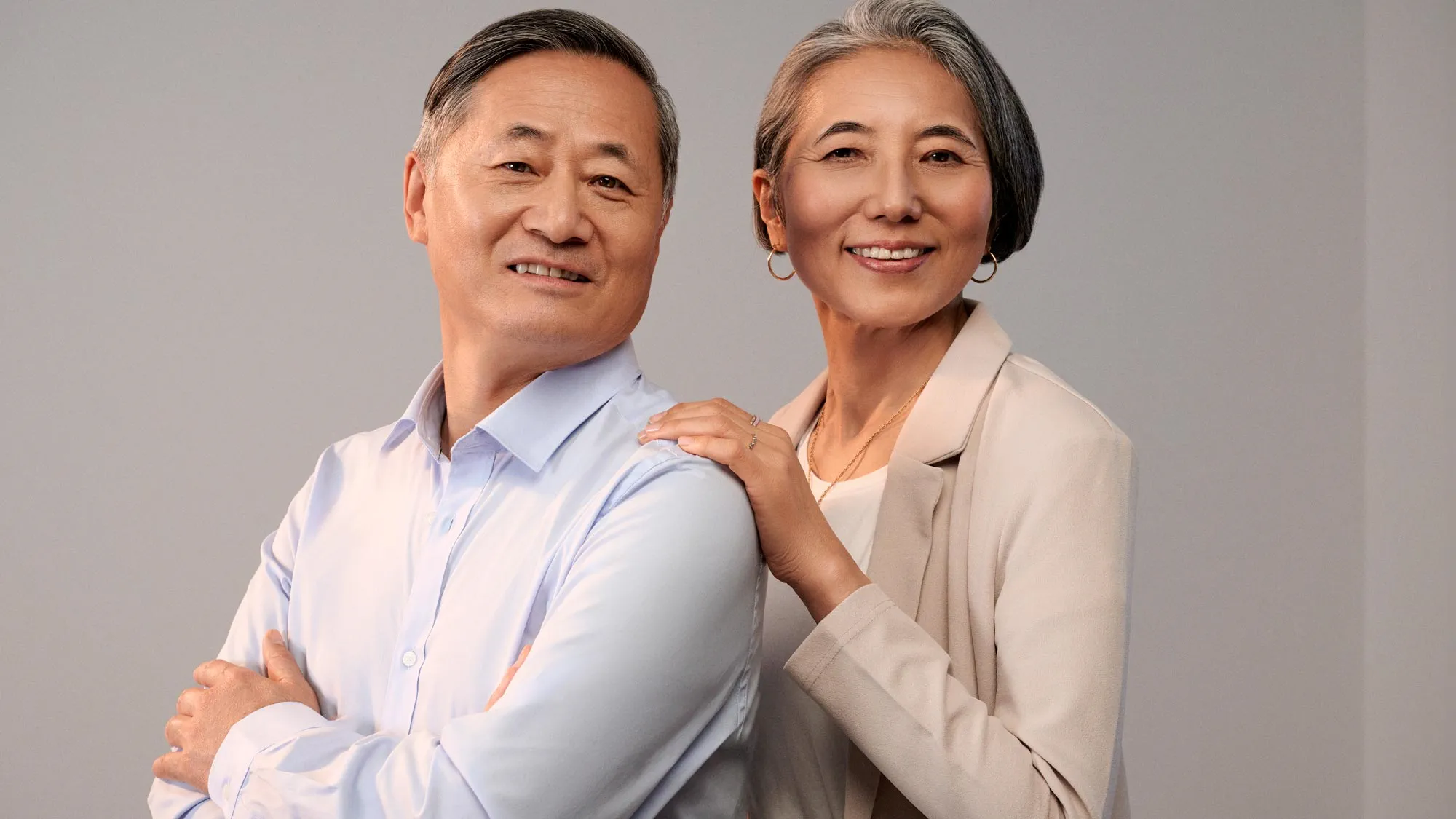 Couple smiling together, indicating hearing improvement.