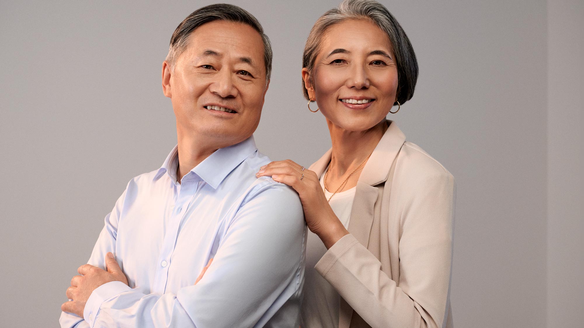 Couple smiling together, indicating hearing improvement.