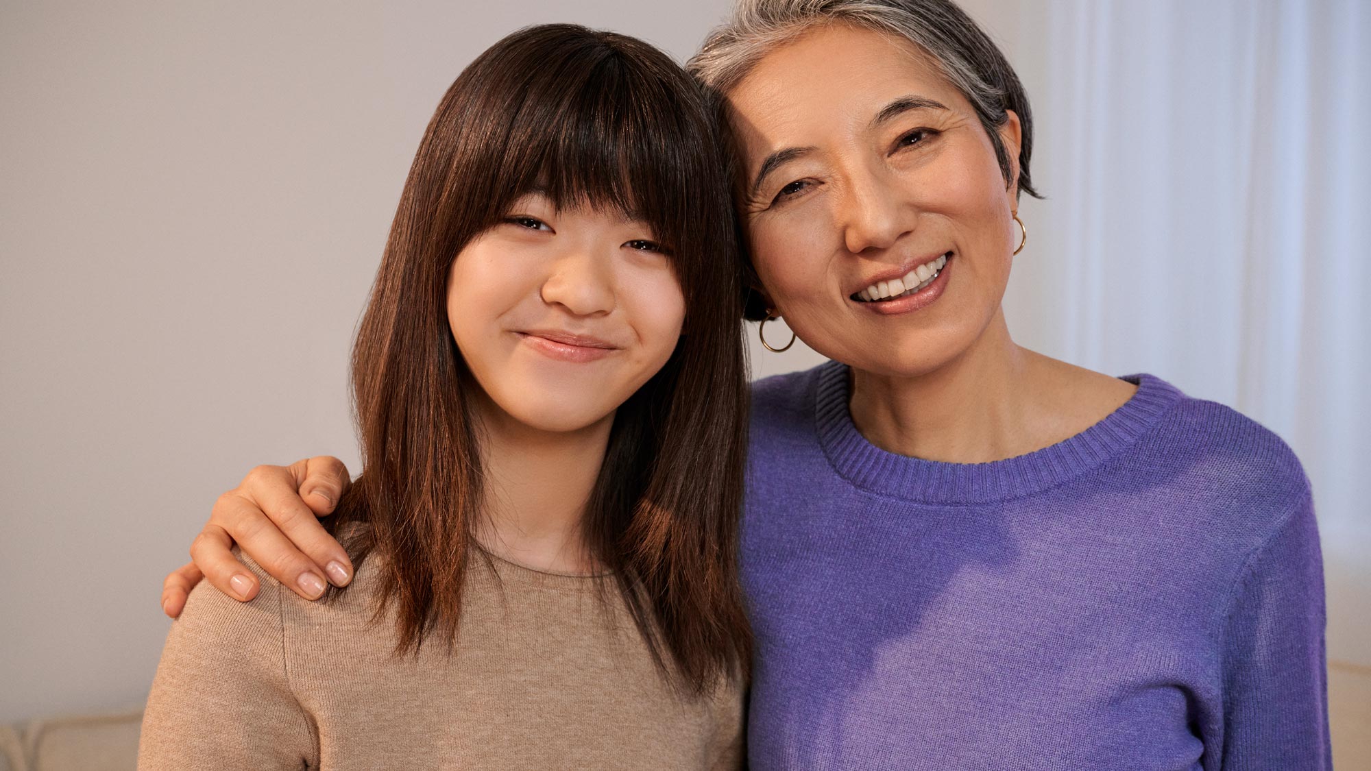 補聴器を装着した少女とそのおばあちゃんの肖像画。
