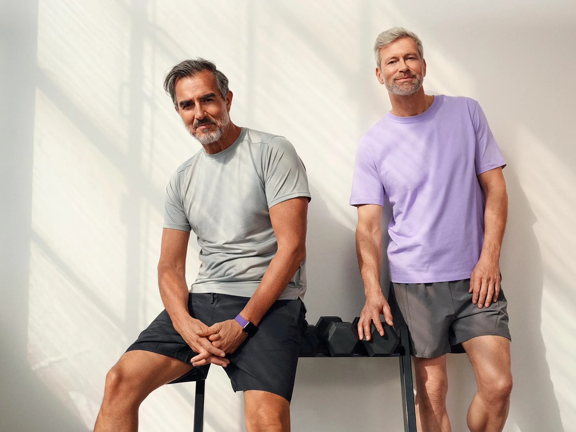 Man standing in the gym, showing his hearing aids.