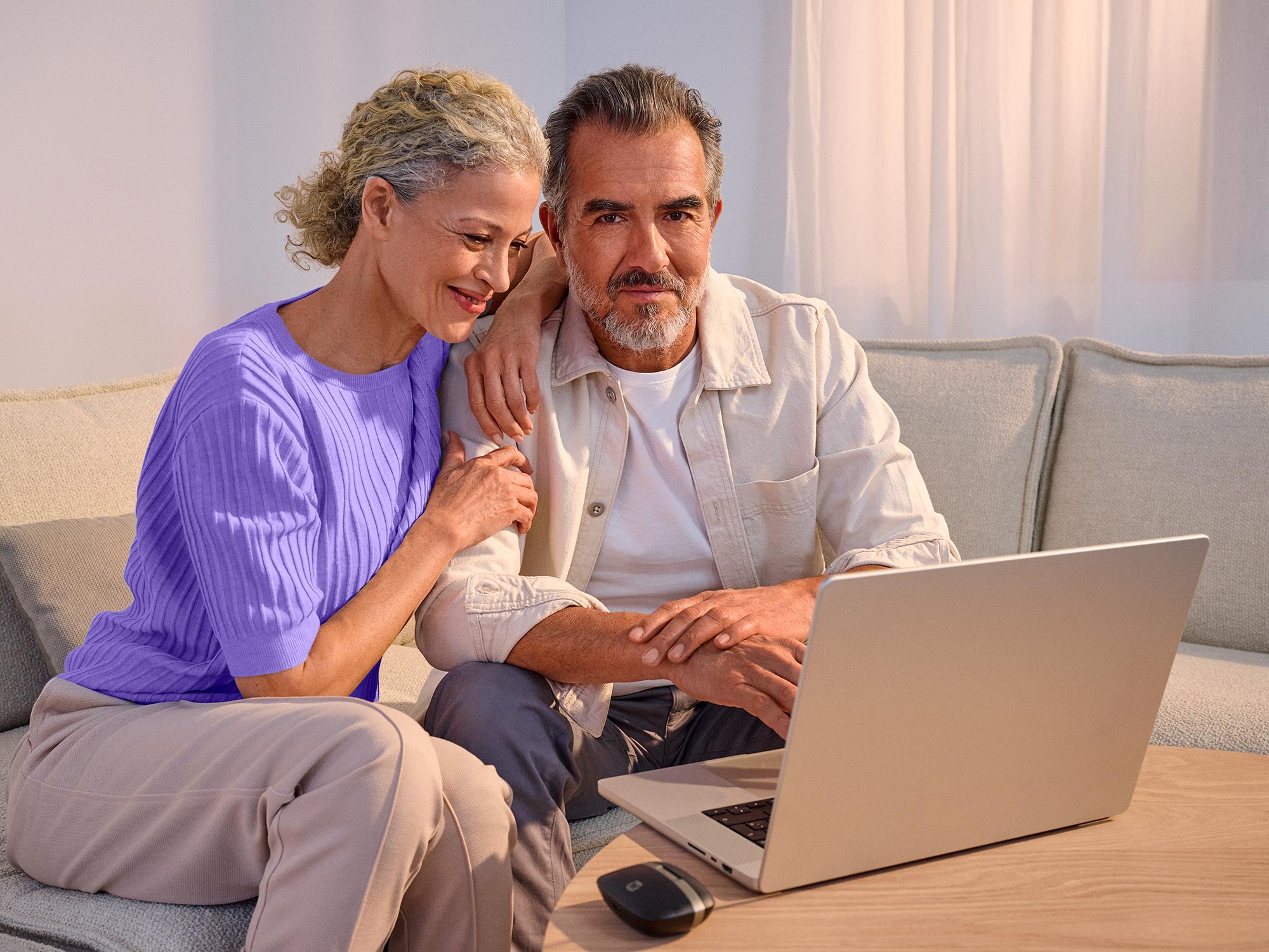 Confident couple using technology, highlighting hearing improvement.