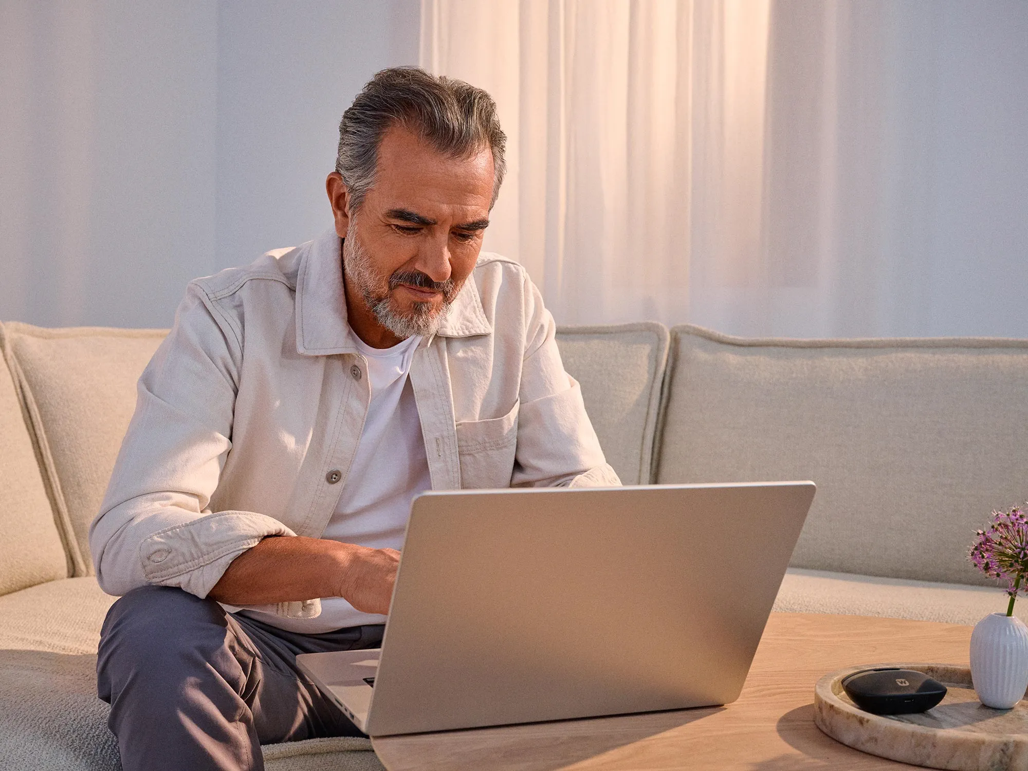 Man researching technology, benefiting from hearing improvement.
