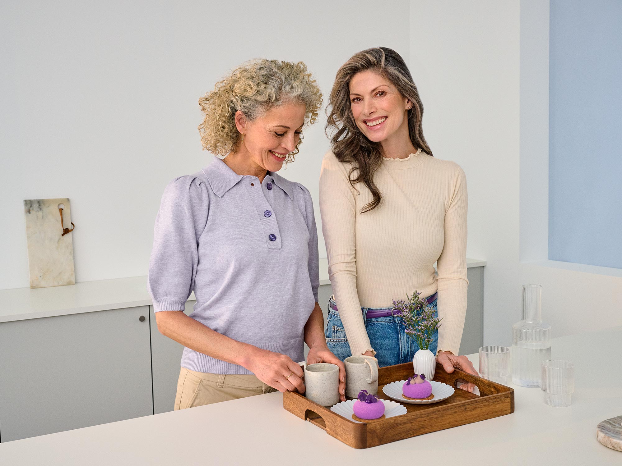 Friends sharing a moment in the kitchen, indicating hearing improvement.