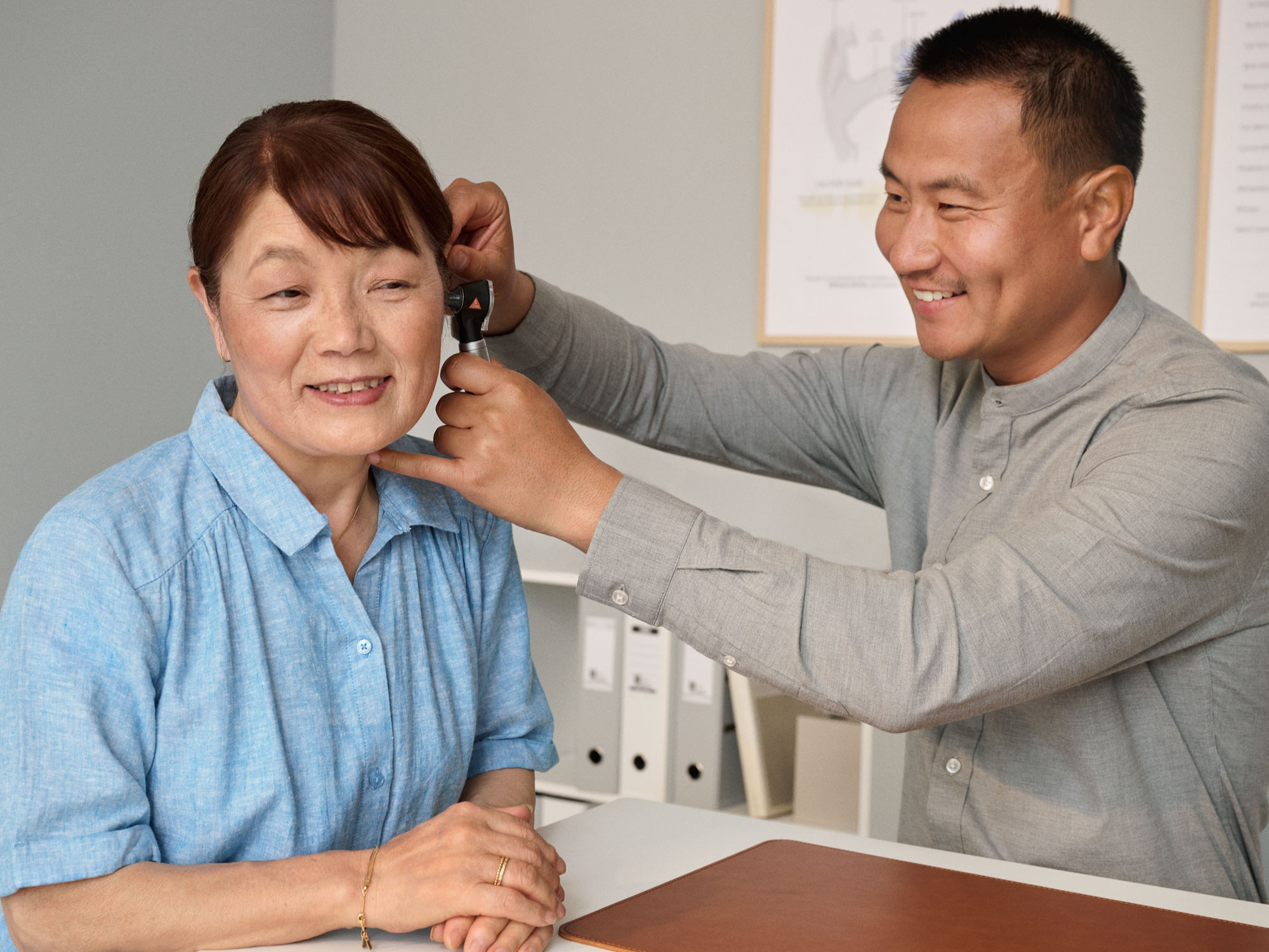 An otoscopy procedure involving both ears being performed during a hearing appointment.