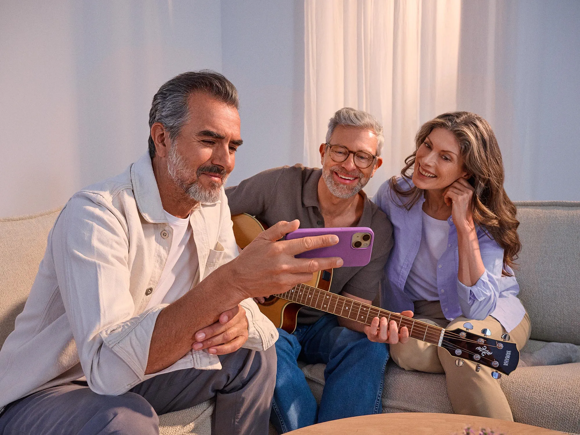 friends-watching-phone-hearing-improvement-4x3
