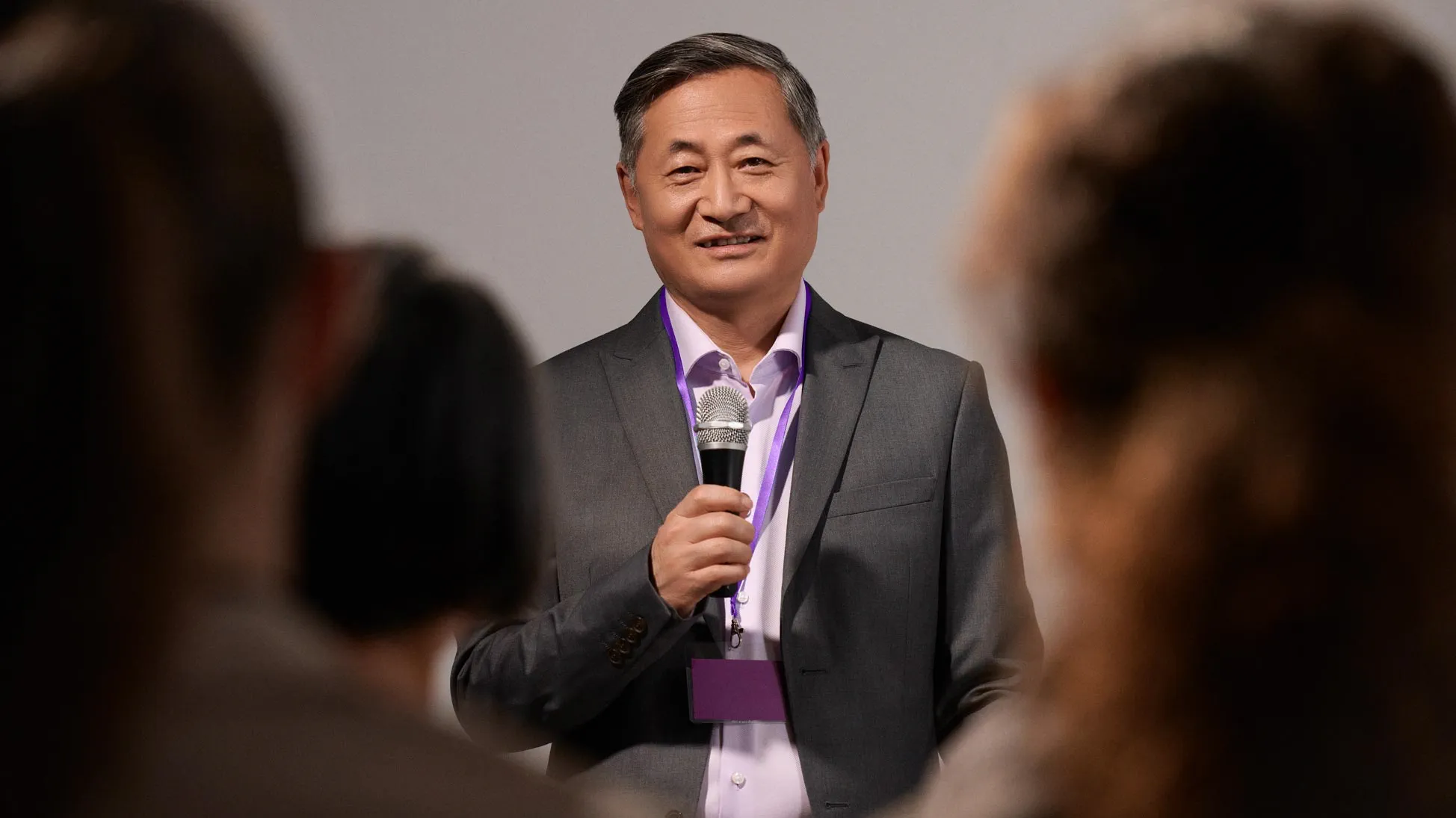 Confident man presenting, wearing hearing aids.